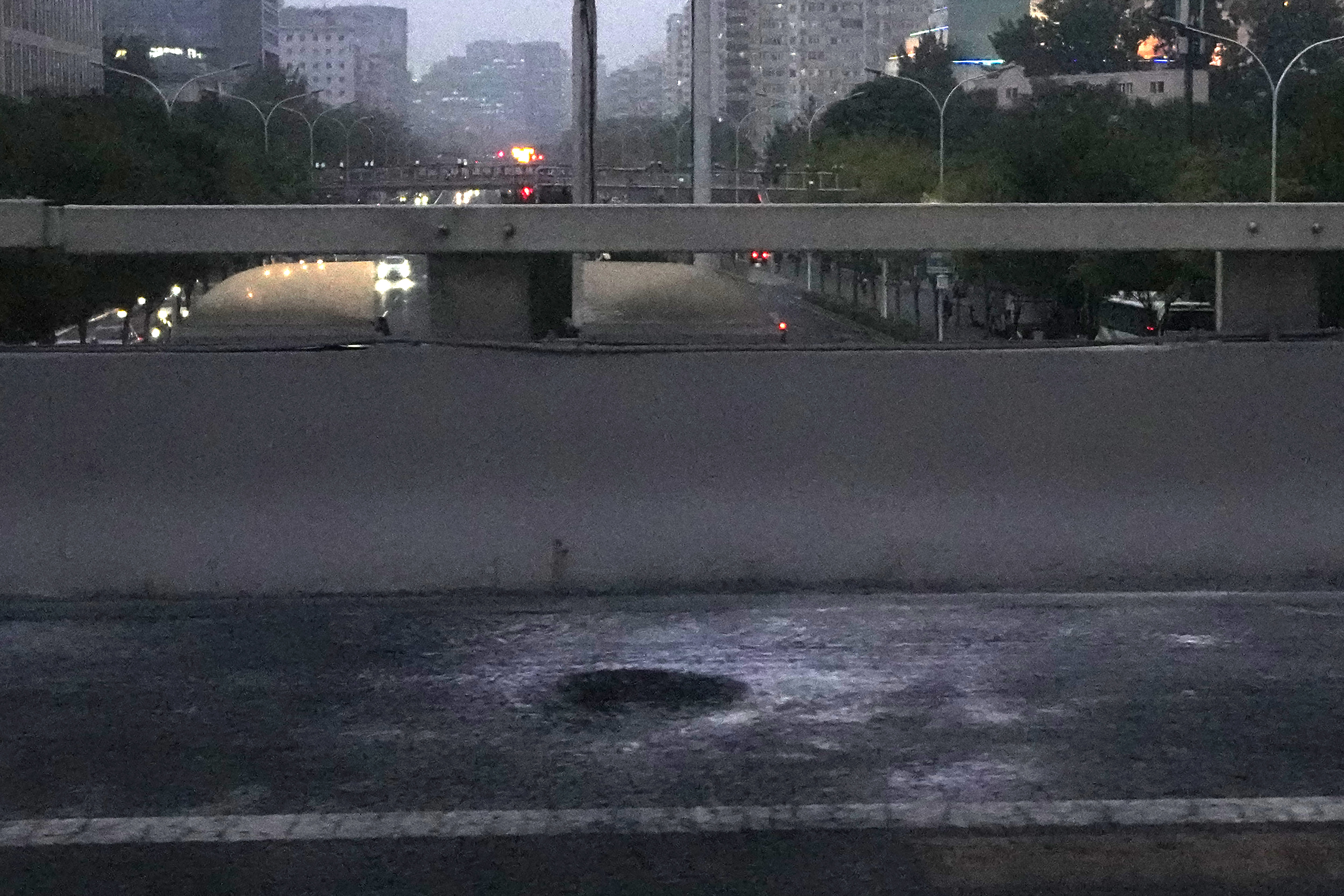 A scorched patch of concrete where banners were hung and flames seen in northwest Beijing on Thursday night