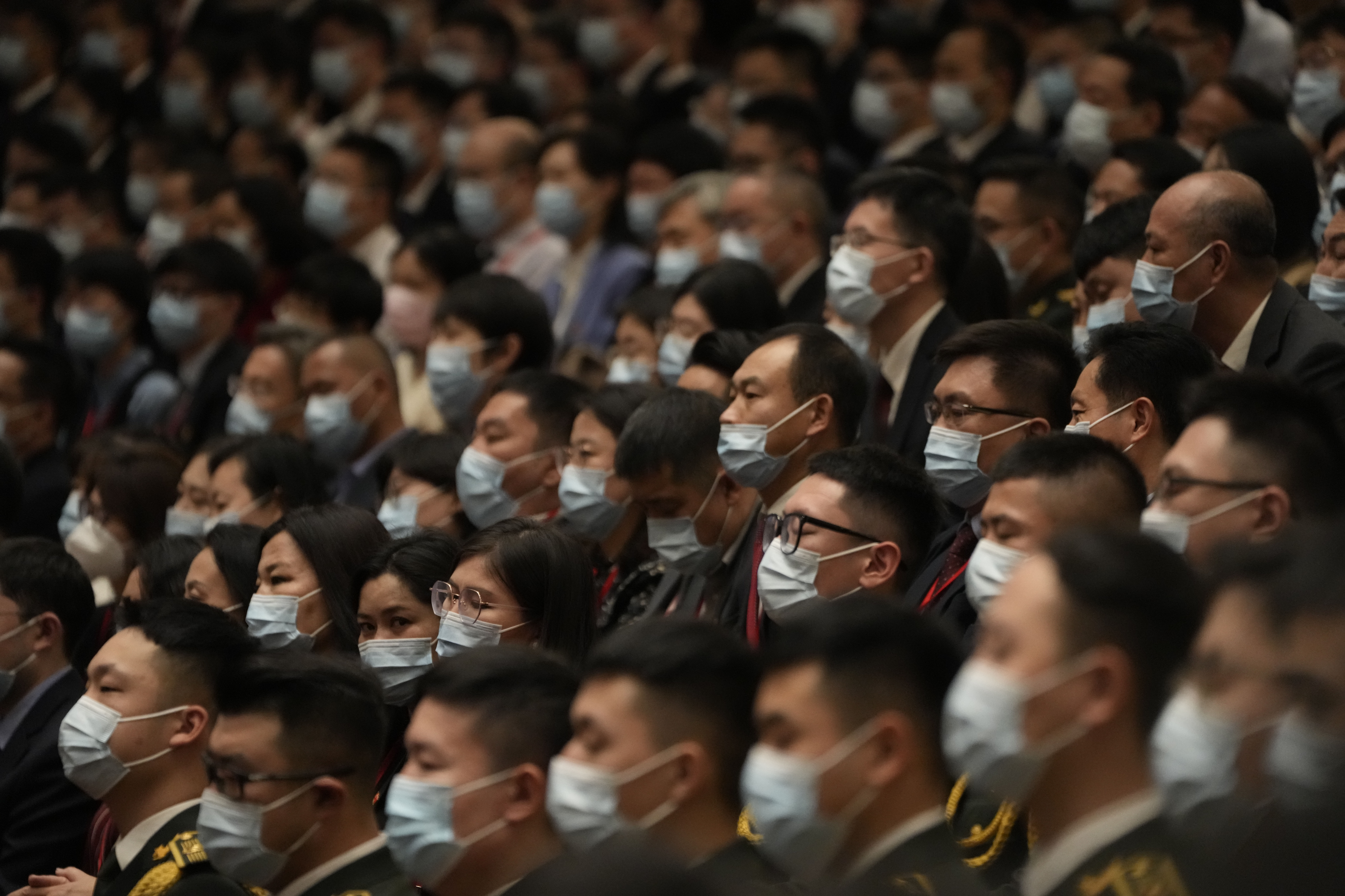 Delegates to the 20th party congress wearing masks as they sit in the Great Hall of the People