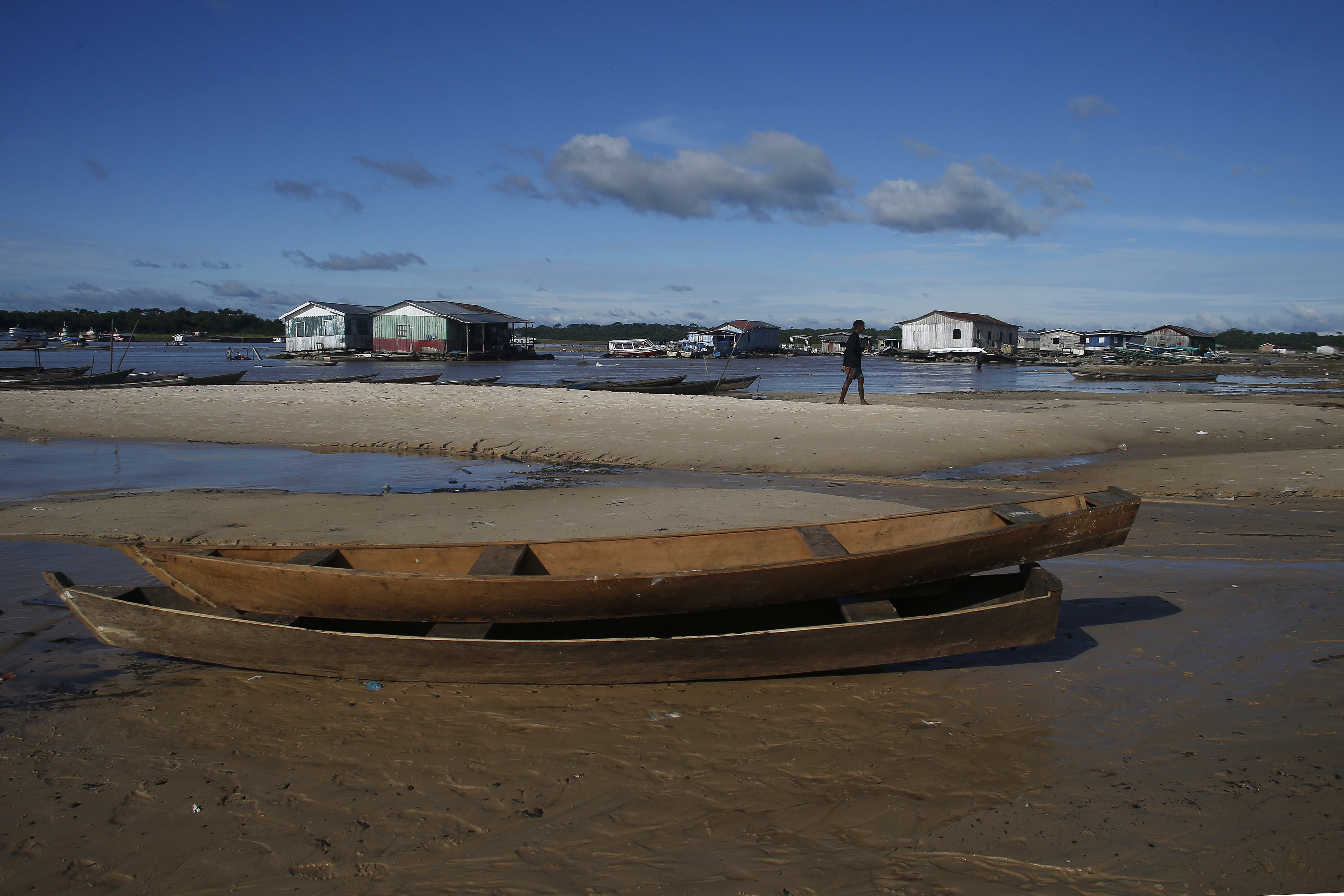A man walks in an area impacted by drought near the Solimões River, in Tefe, Amazonas state, Brazil