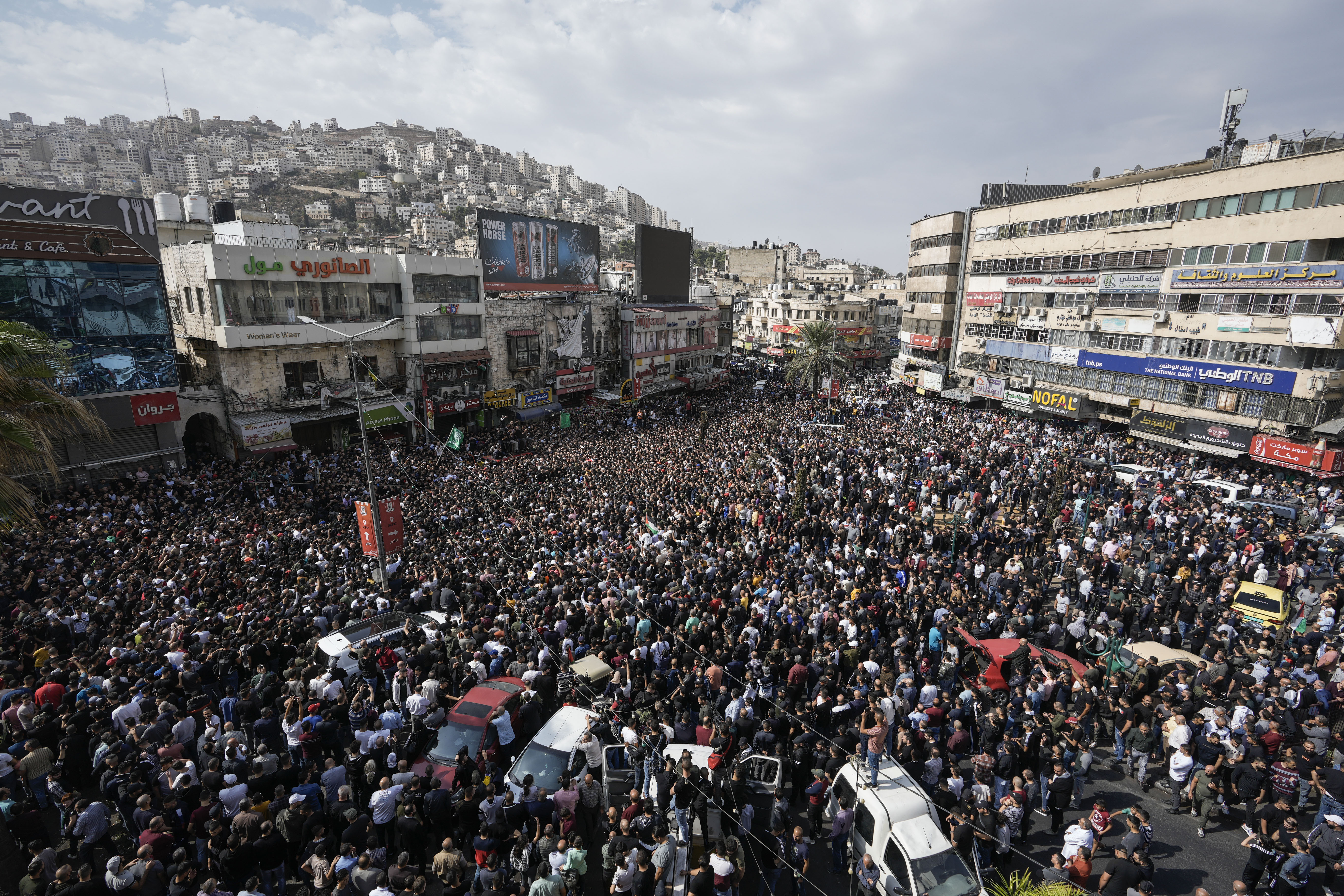 Mourners attend the funeral of Palestinians killed in an overnight Israeli raid, in the occupied West Bank city of Nablus