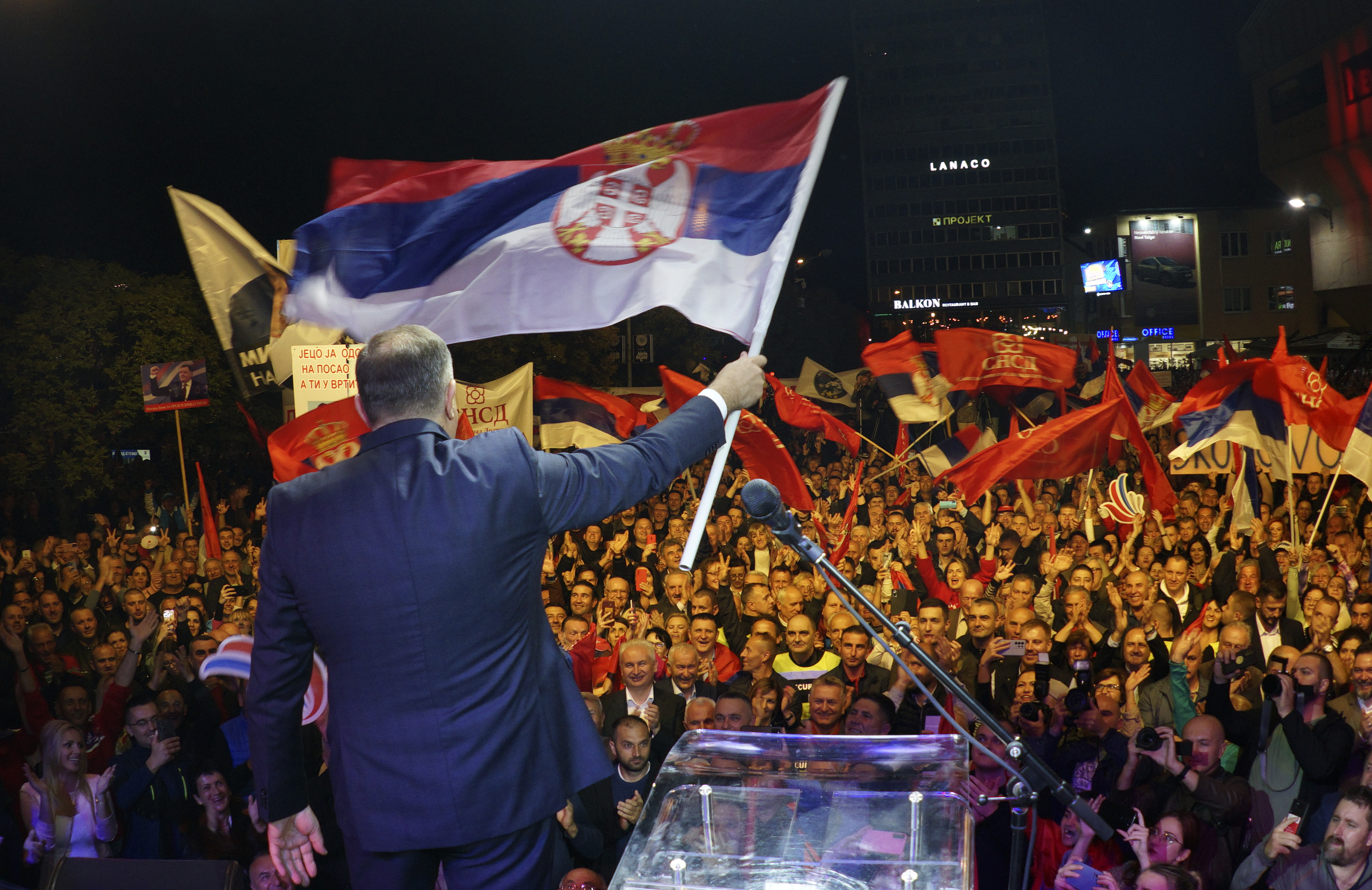 Bosnian Serb leader Milorad Dodik waves a Serbian flag during a protest against state election commission of Bosnia, which is likely to announce a re-run of presidential elections following allegations of fraud in favor of Dodik in the Bosnian town of Banja Luka, 240 kms northwest of Sarajevo, Tuesday, Oct. 25, 2022. Opposition leaders claim that their candidate Jelena Trivic is the winner, and that Dodik rigged the ballot. (AP Photo/Radivoje Pavicic)