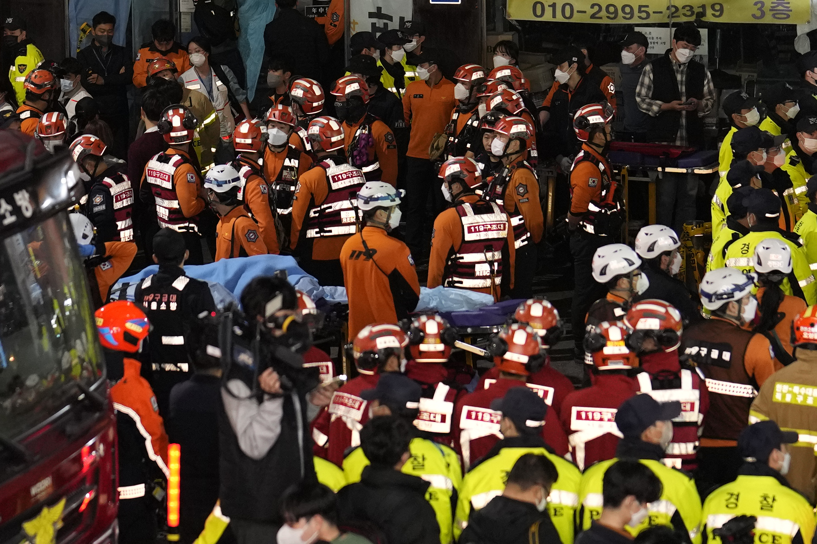 Dozens of rescue workers, firefighters and police officers are seen on the street near the scene of the stampede in Seoul, South Korea.