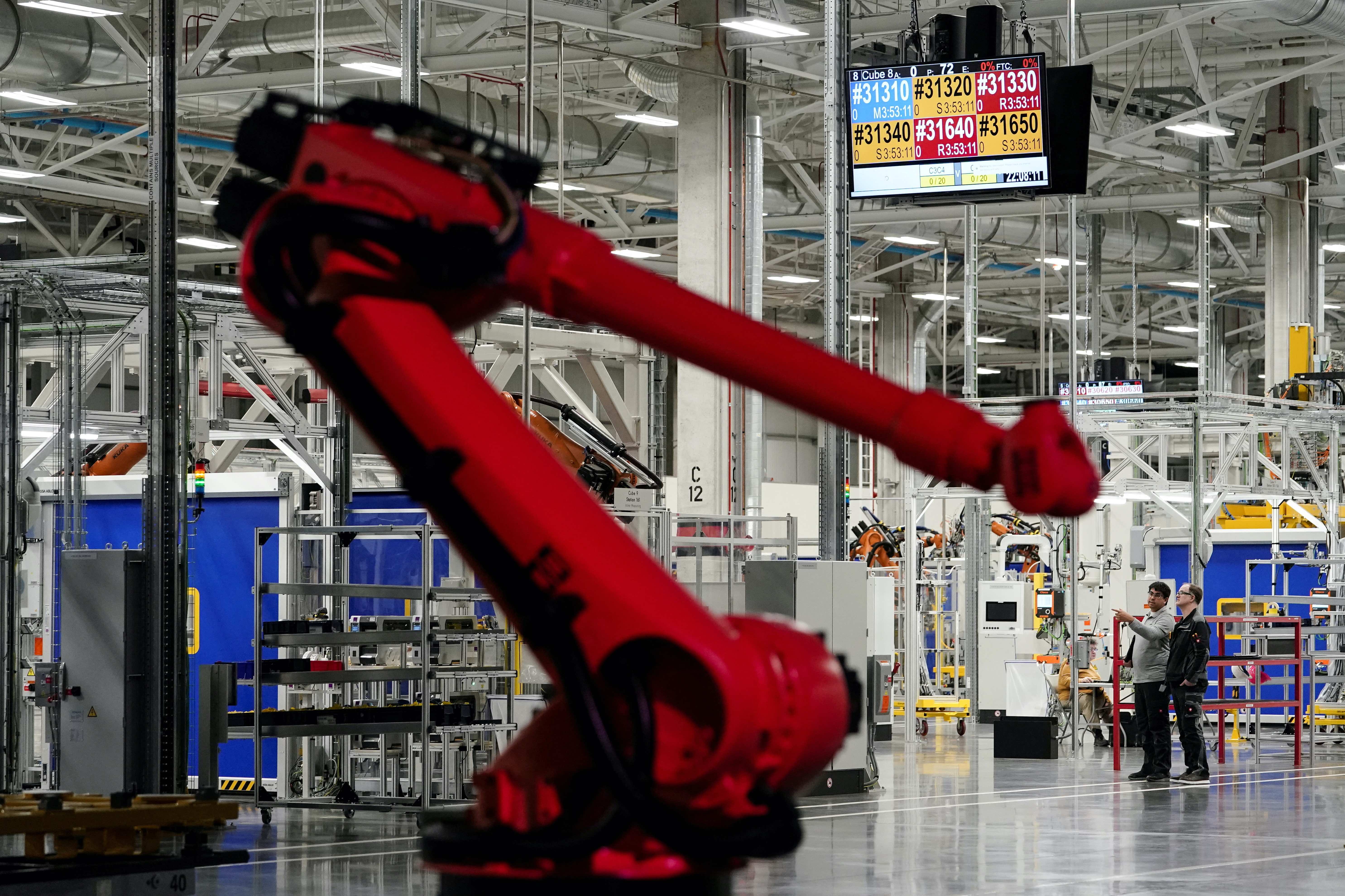 People are seen on the manufacturing floor at the opening of a Mercedes-Benz electric vehicle Battery Factory, marking one of only seven locations producing batteries for their fully electric Mercedes-EQ models, in Woodstock, Alabama, U.S