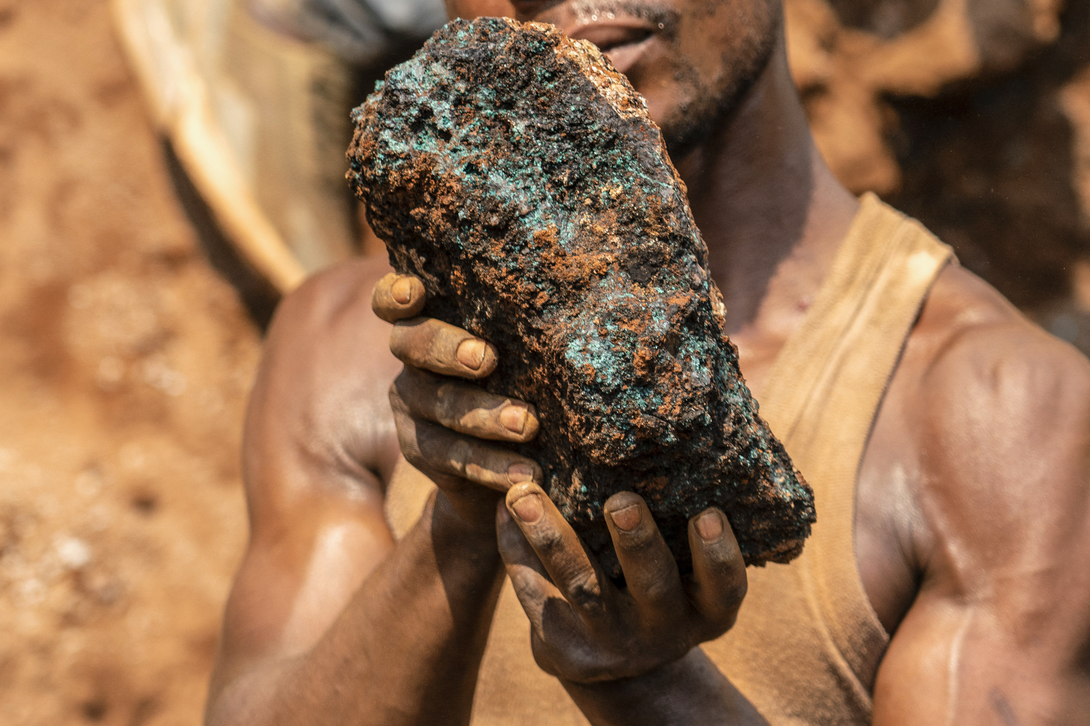 An artisanal miner holds a cobalt stone.