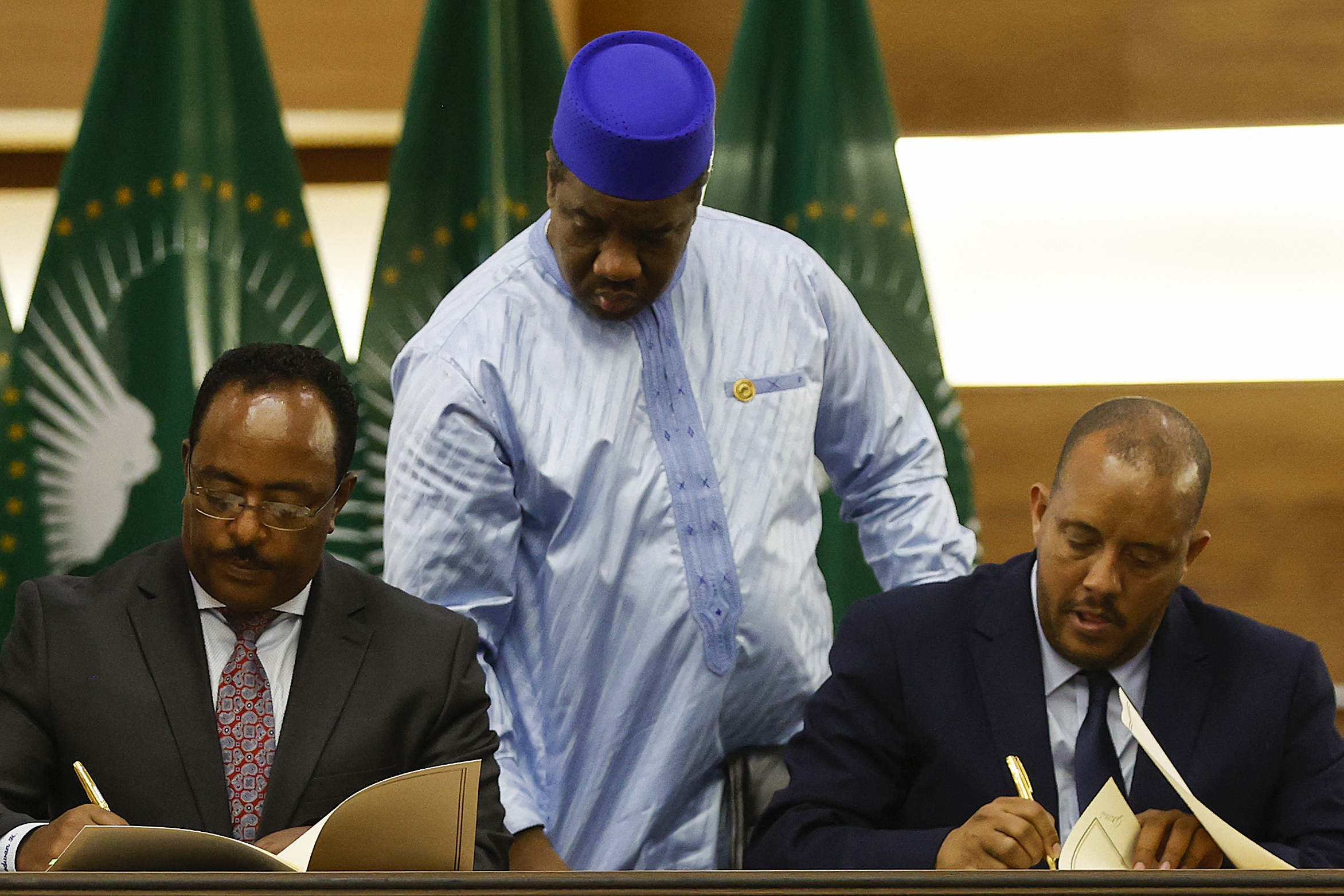 Redwan Hussein (L), Representative of the Ethiopian government, and Getachew Reda (R), Representative of the Tigray People's Liberation Front (TPLF), sign a peace agreement between the two parties during a press conference regarding the African Union-led negotiations to resolve conflict in Ethiopia at the Department of International Relations and Cooperation (DIRCO) offices in Pretoria on November 2, 2022.