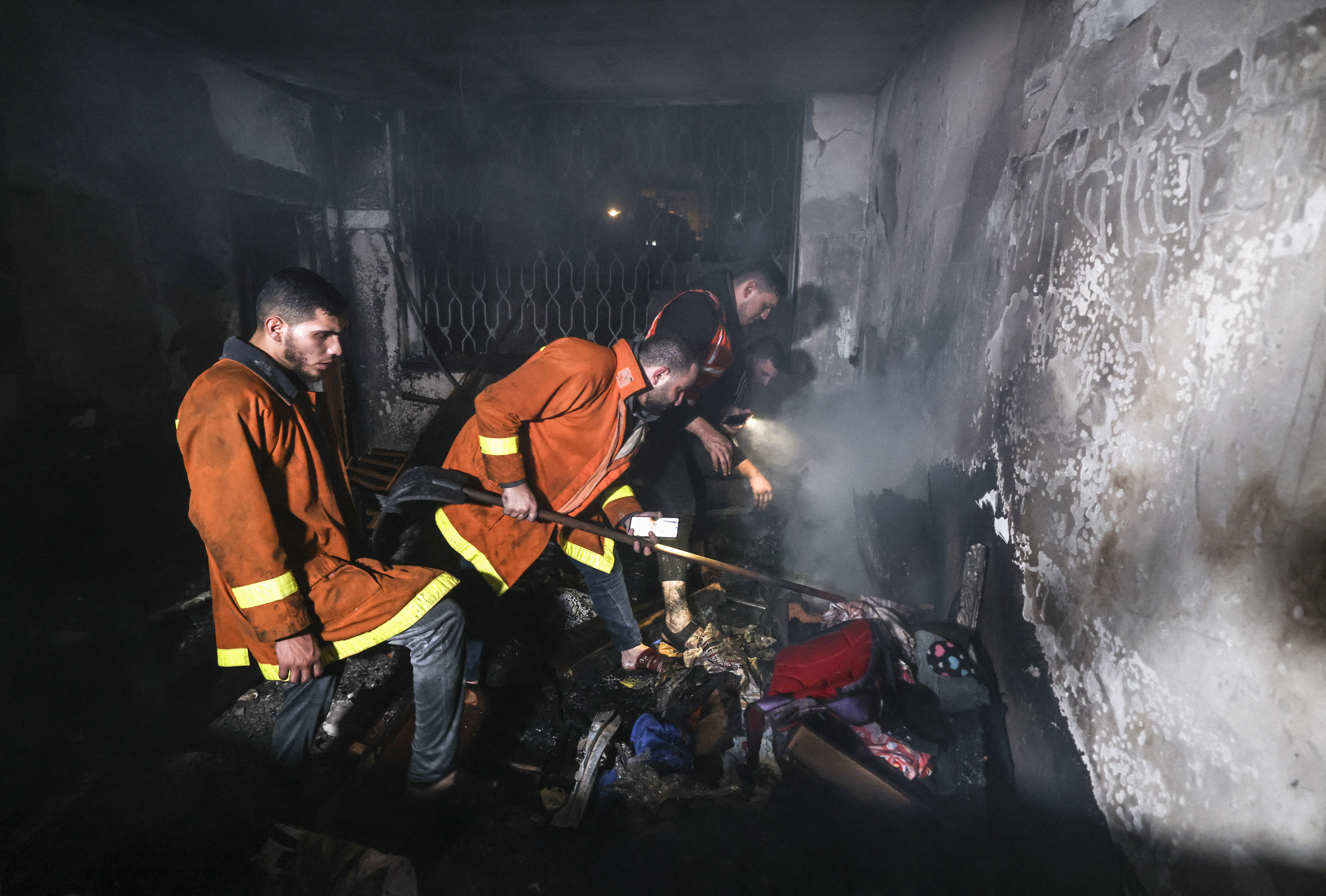 Palestinian firefighters extinguish a fire in Gaza.