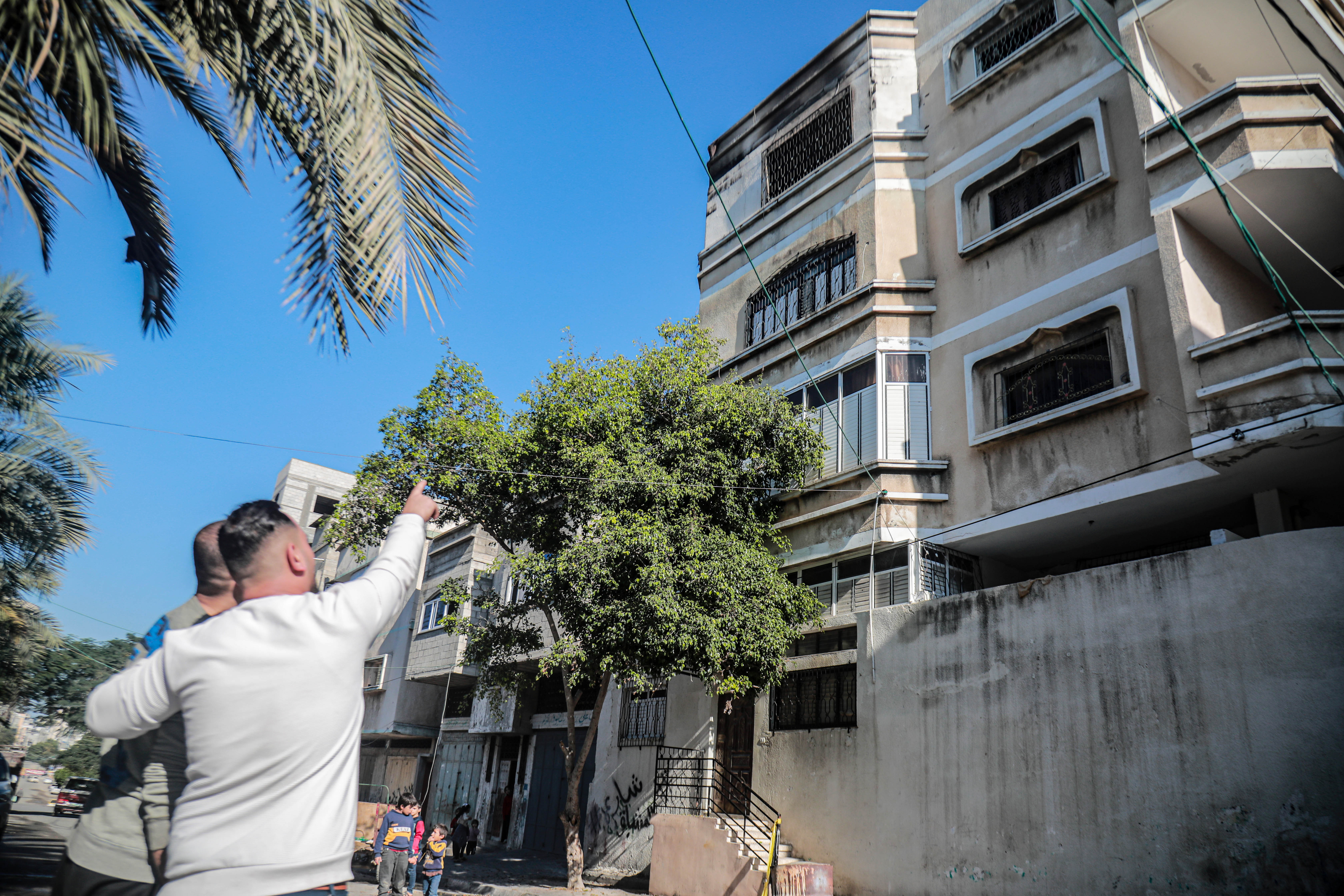 A man points to the fire place.