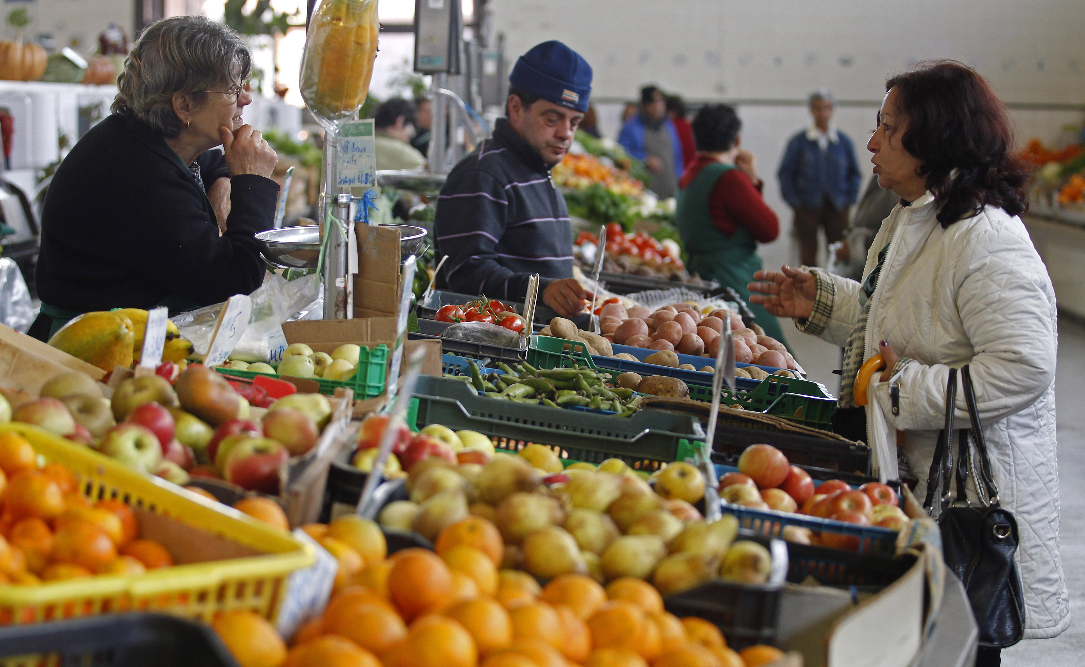 People talk at the vegetable market in Olhao in the southern Portuguese province of Algarve