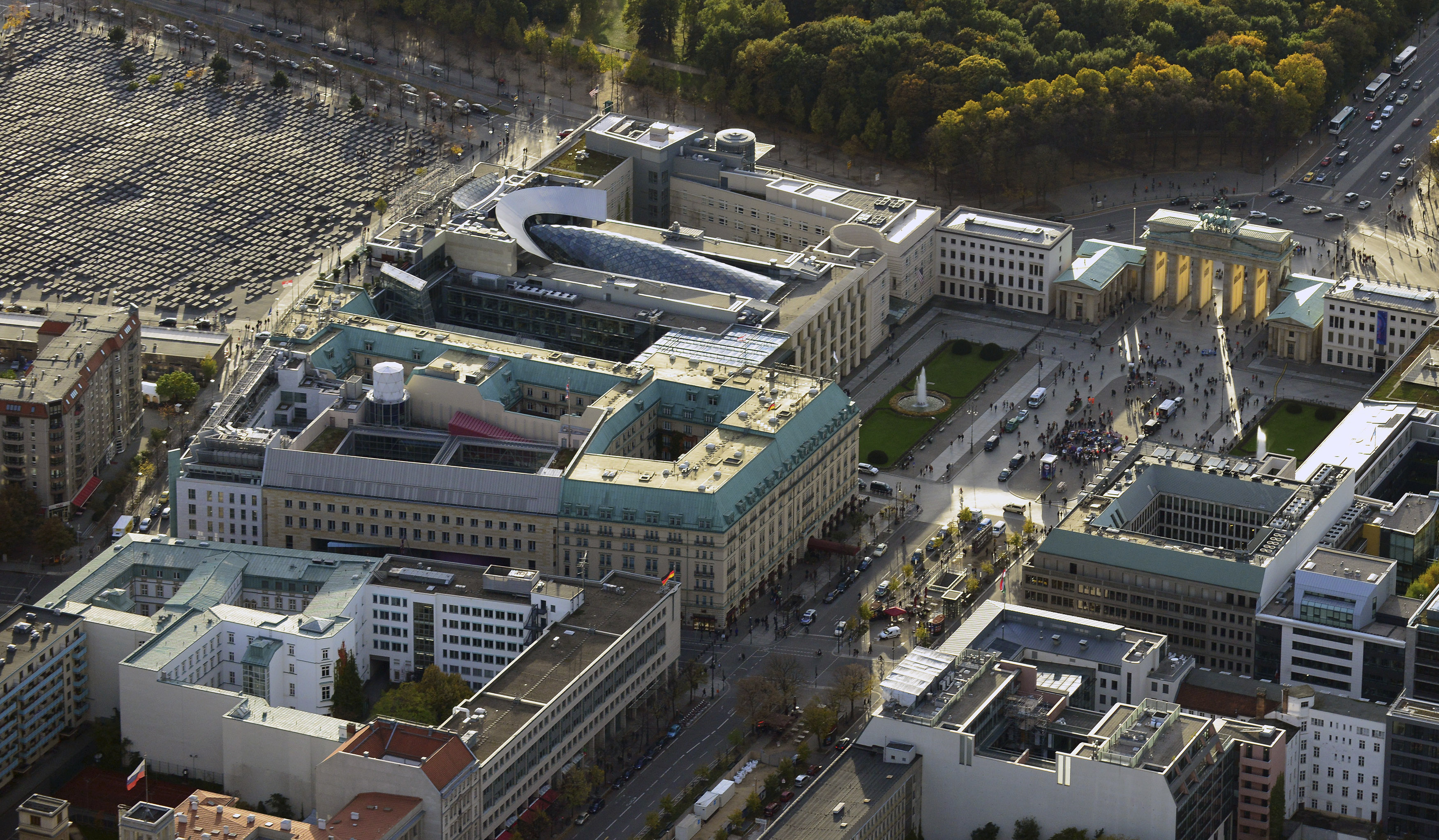 An aerial view over the British embassy (centre L) Hotel Adlon (lower L) the Acadamy of Arts and the U.S. Embassy (top) between the Holocaust memorial (top L) and the public square Pariser Platz with the Brandenburg Gate (top R) towards the Tiergarten in Berlin October 18, 2013. Documents leaked by former U.S. National Security Agency contractor Edward Snowden show that Britain's surveillance agency is operating a network of "electronic spy posts" from within a stone's throw of the Bundestag and German chancellor's office, the Independent reported. NSA documents, in conjunction with aerial photographs and information about past spying activities in Germany, suggest that Britain is operating its own covert listening station close to the German parliament, and Chancellor Angela Merkel's offices in the Chancellery, using hi-tech equipment housed on the embassy roof, the British newspaper reported. Picture taken October 18. REUTERS/Euroluftbild.de/Robert Grahn (GERMANY - Tags: CITYSPACE POLITICS)