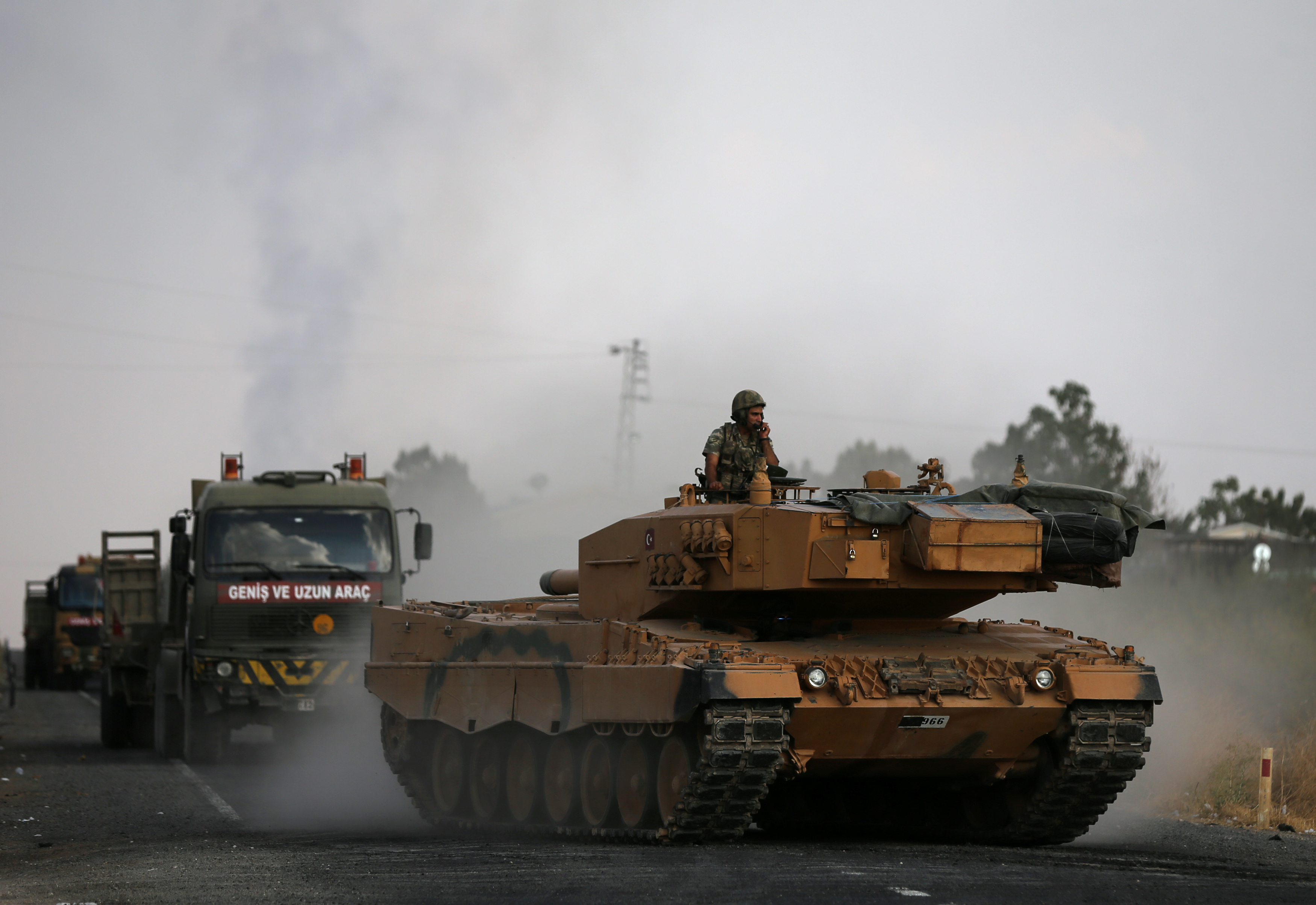 Turkish army vehicles are moving on a road near the Turkish border town of Ceylanpinar, Sanliurfa province, Turkey, October 18, 2019