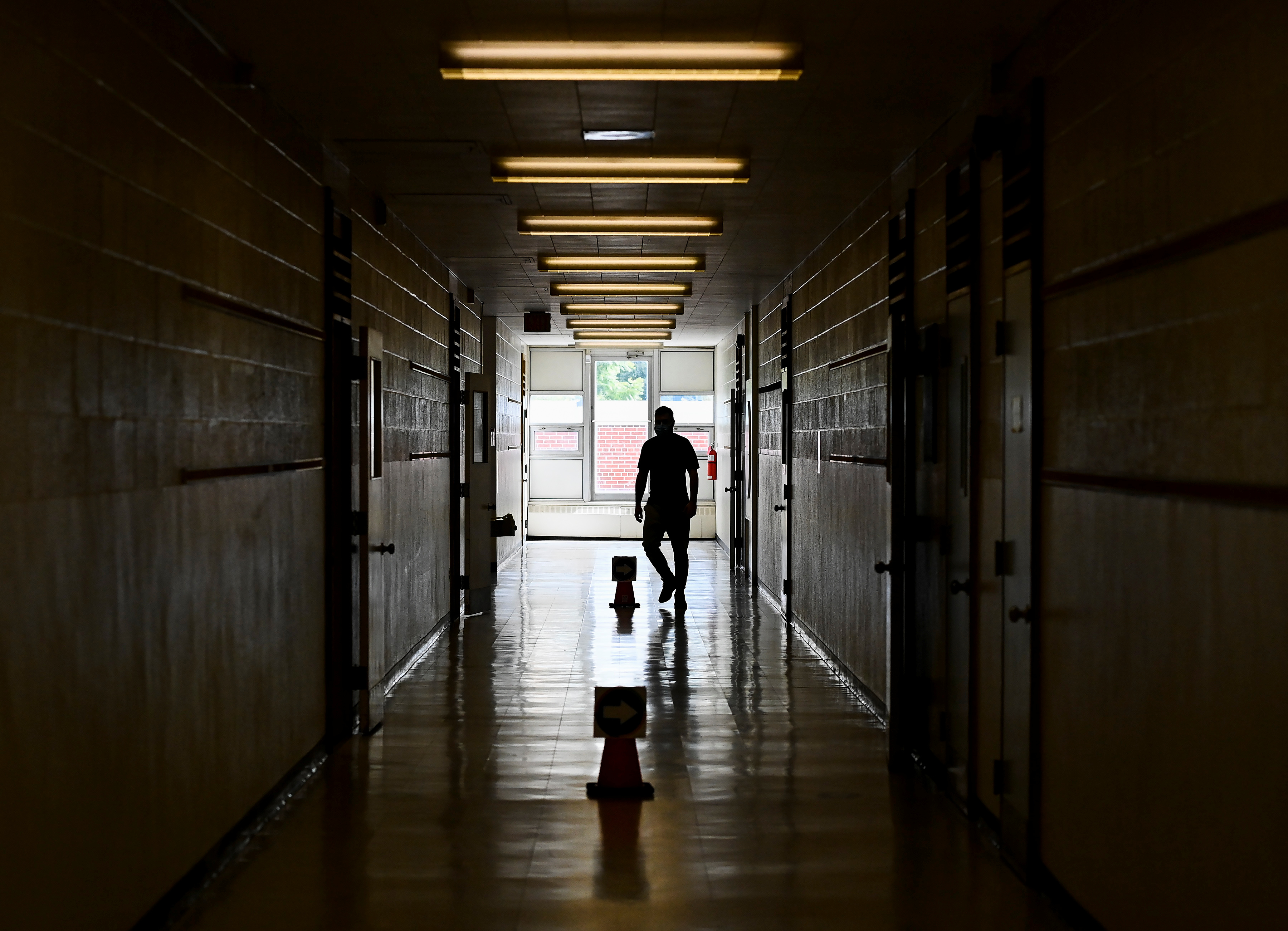 a teacher walks in a hallway in an Ontario school