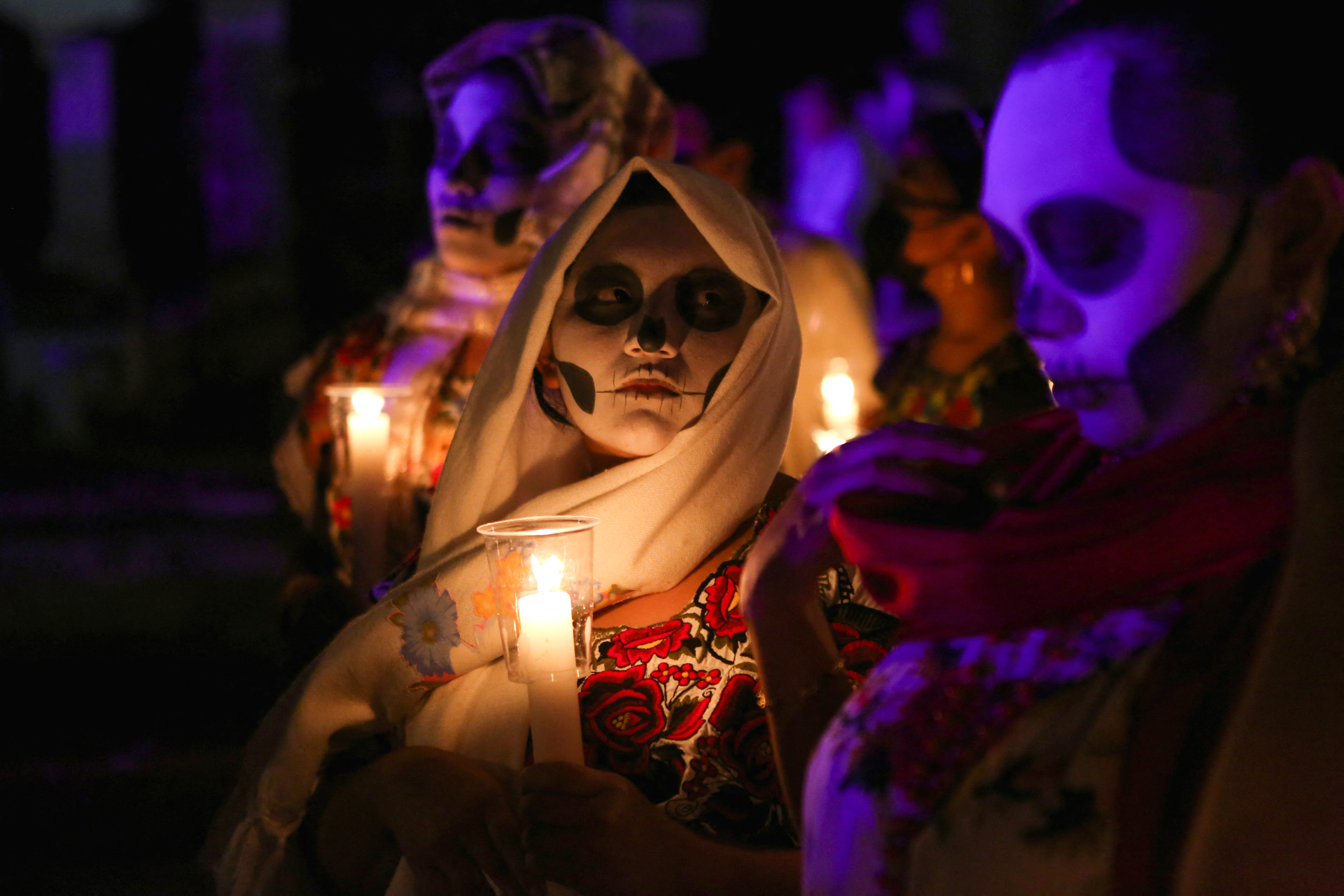 People with their faces painted as skulls