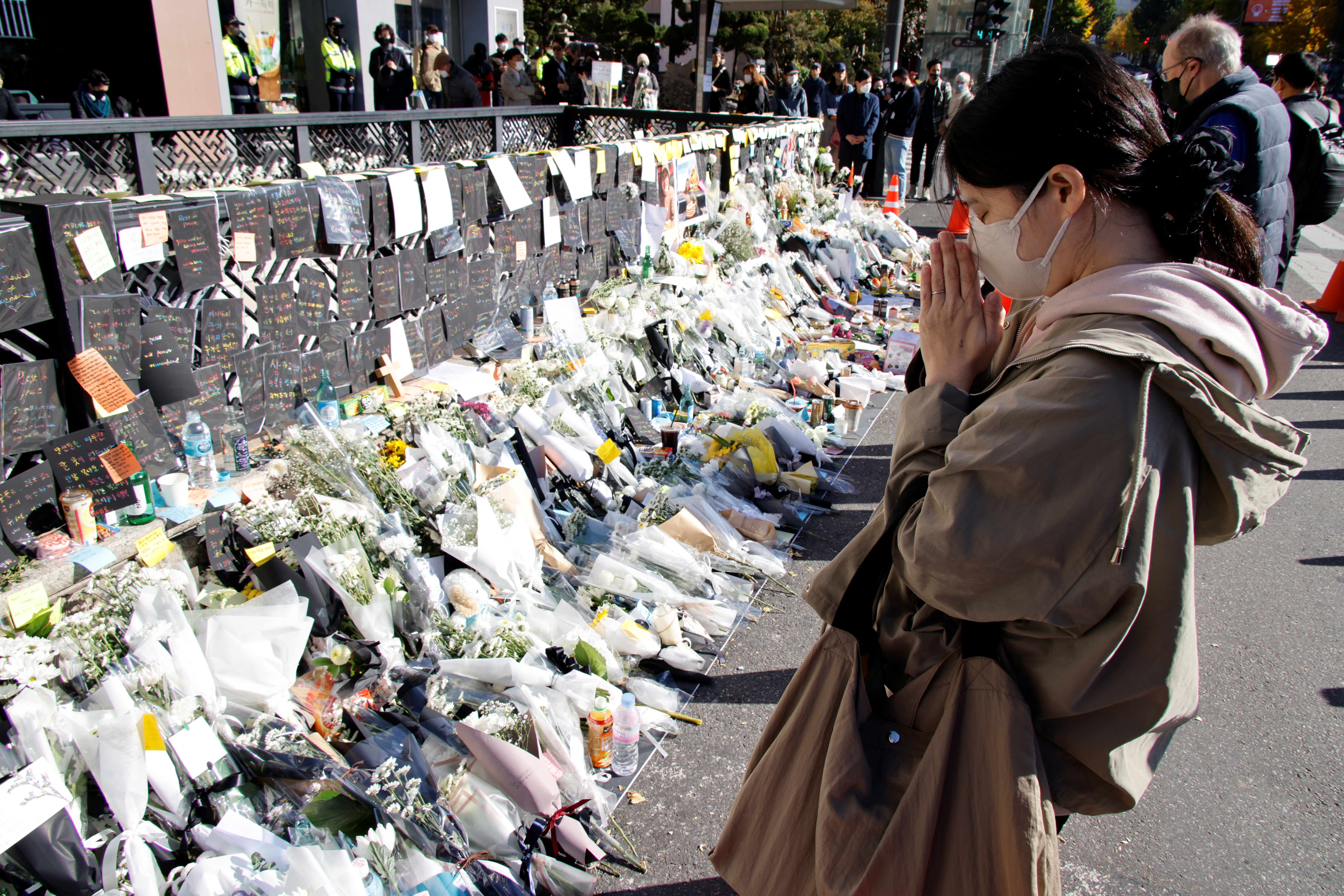 People pay respects near the scene of a crowd crush.