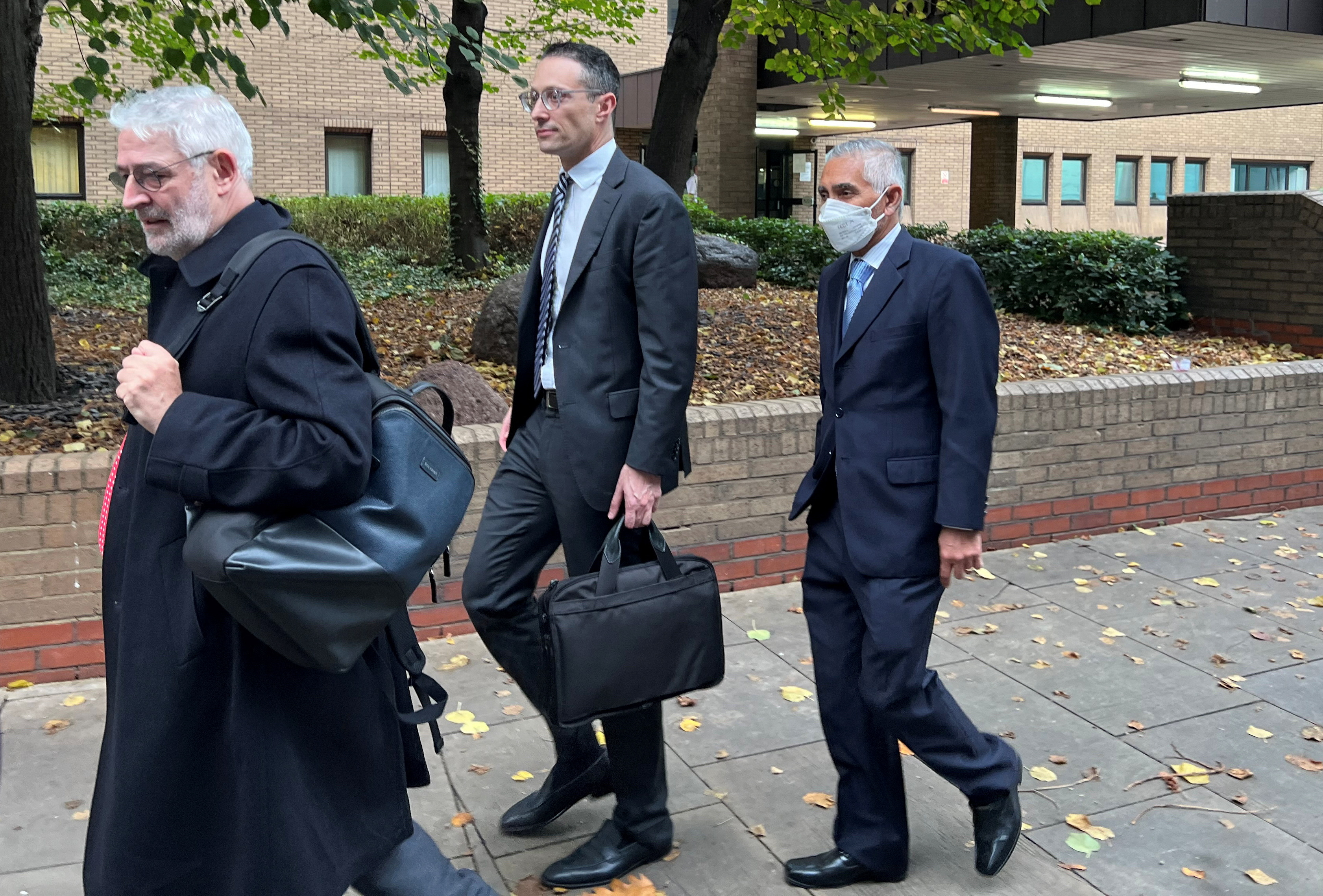 Glencore's chairman Kalidas Madhavpeddi and Glencore's general counsel Shaun Teichner leave Southwark Crown Court 