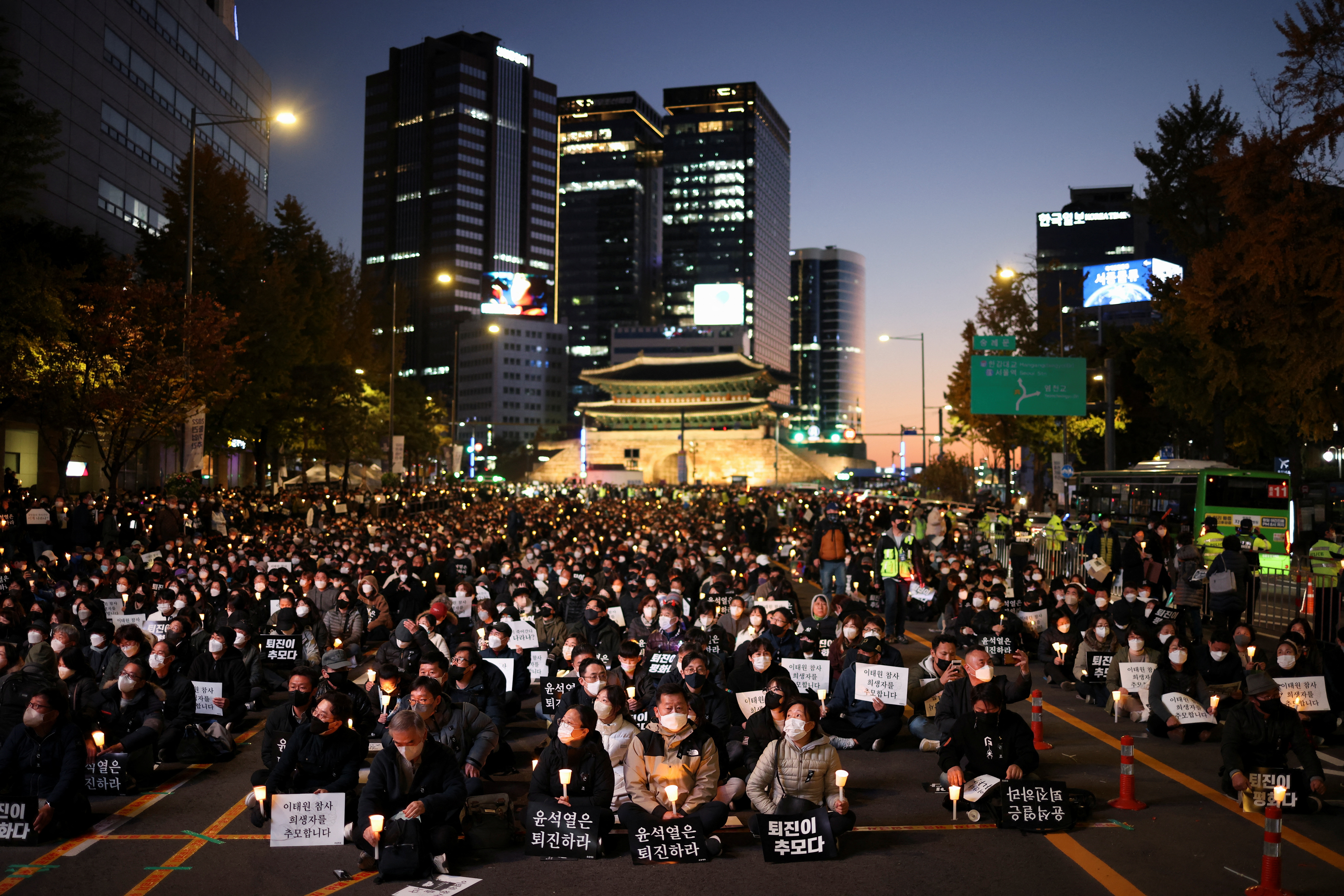 People attend a candlelight vigil to commemorate the victims of the crowd crush.