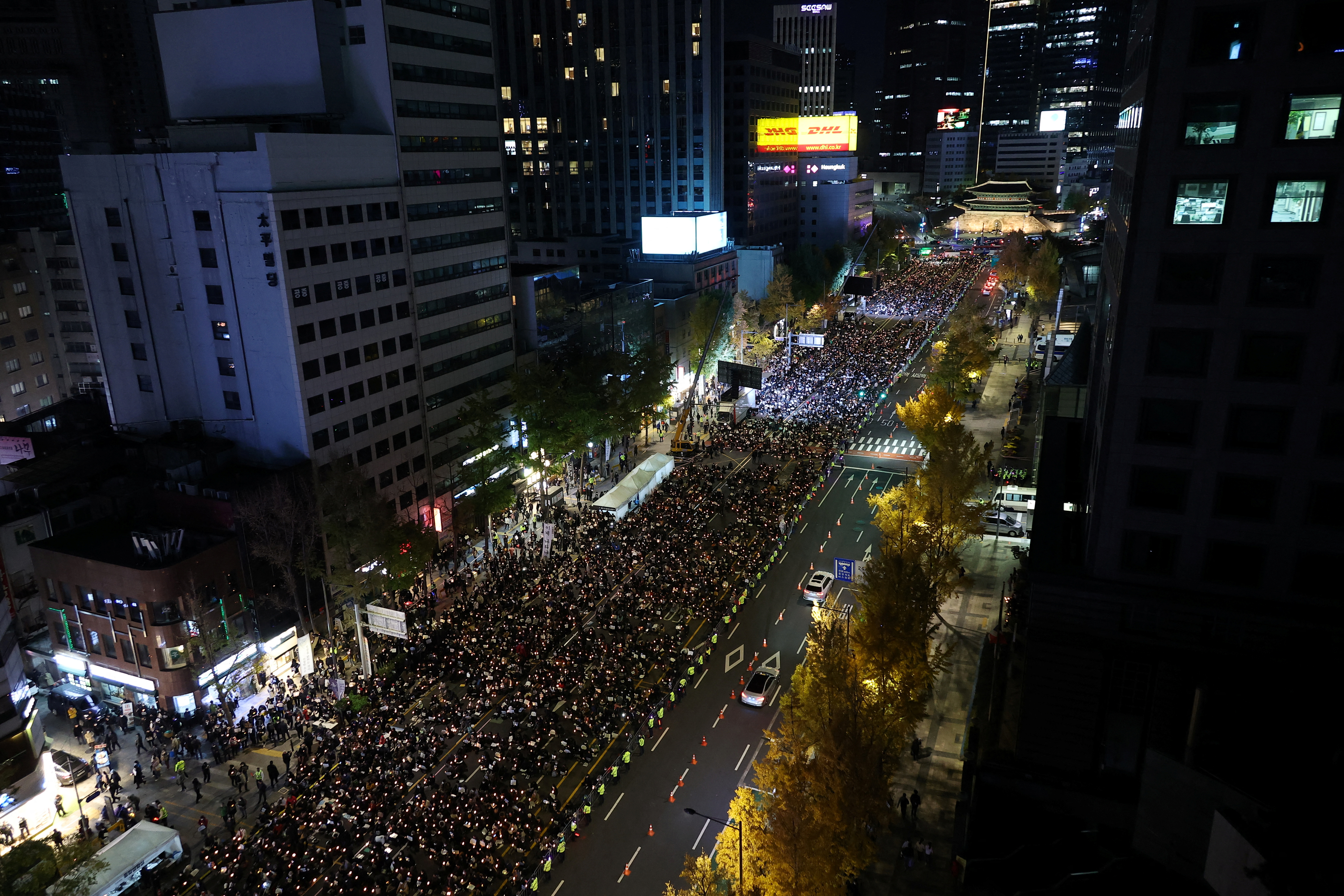 People attend a candlelight vigil to commemorate the victims of the crowd crush.