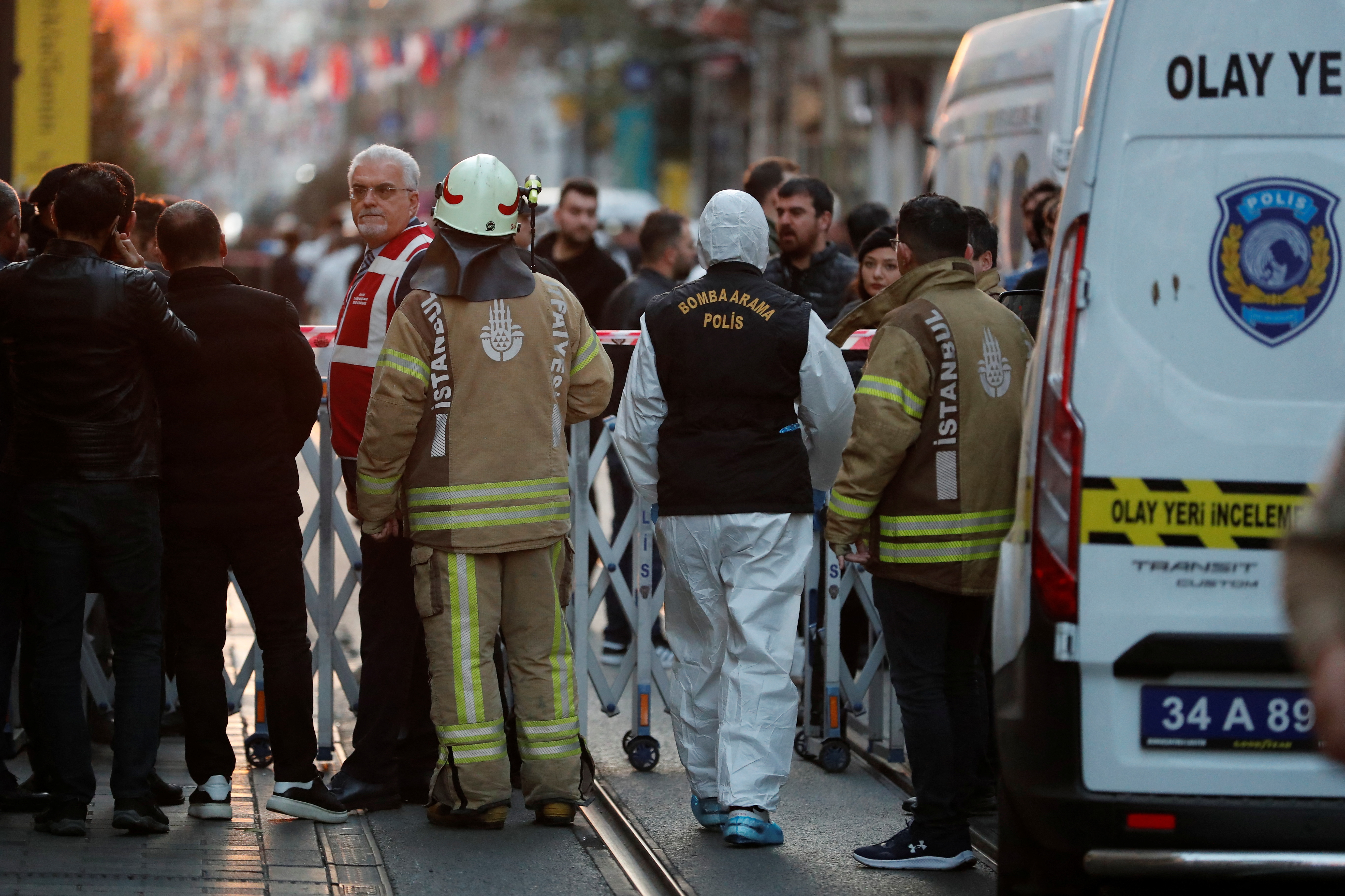 Police and emergency service members work at the scene after an explosion.