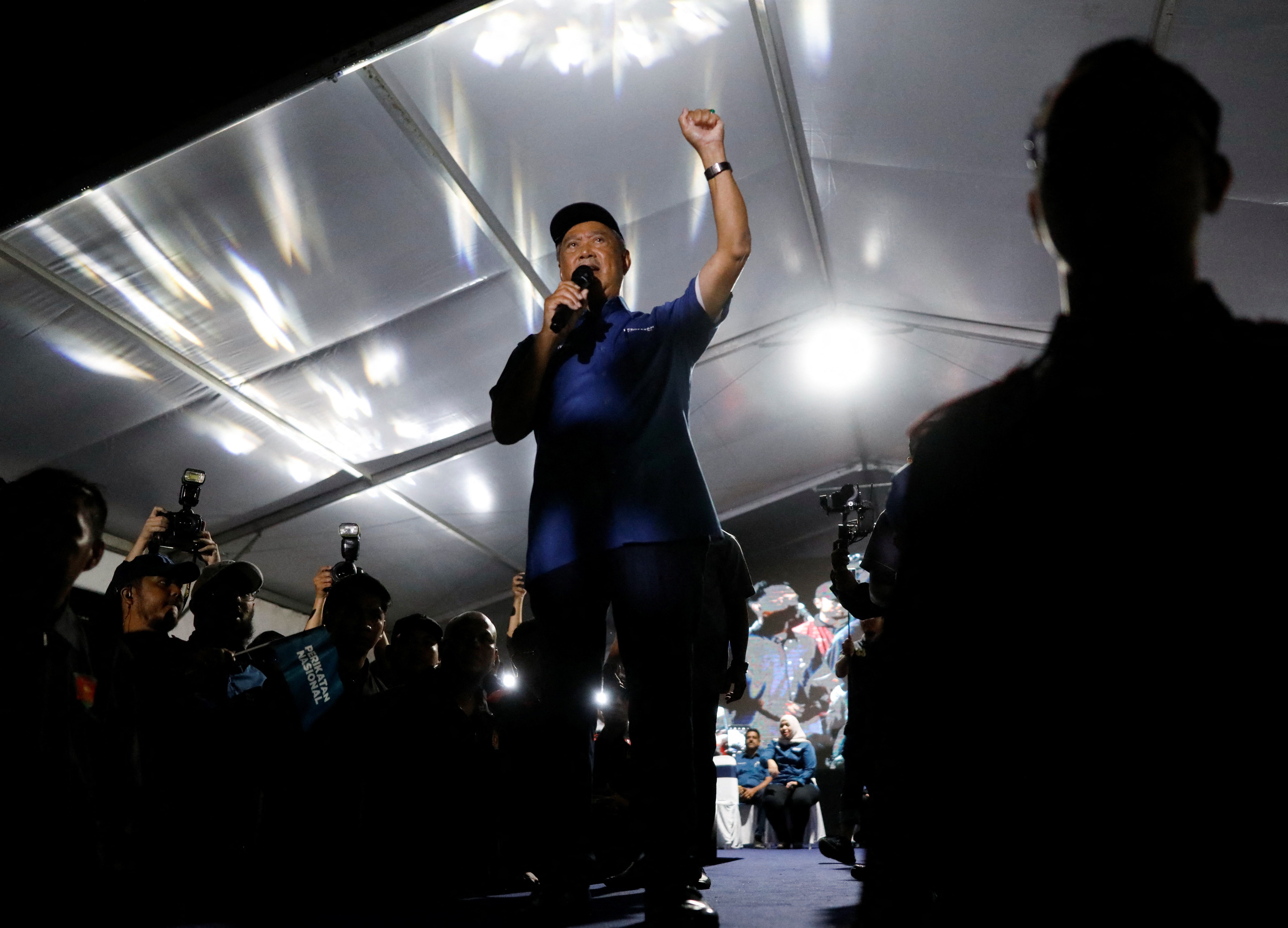 Muhyuddin Yassin, a former Malaysian prime minister, raises his arm as he speaks at a nighttime rally in Kuala Lumpur, Malaysia.
