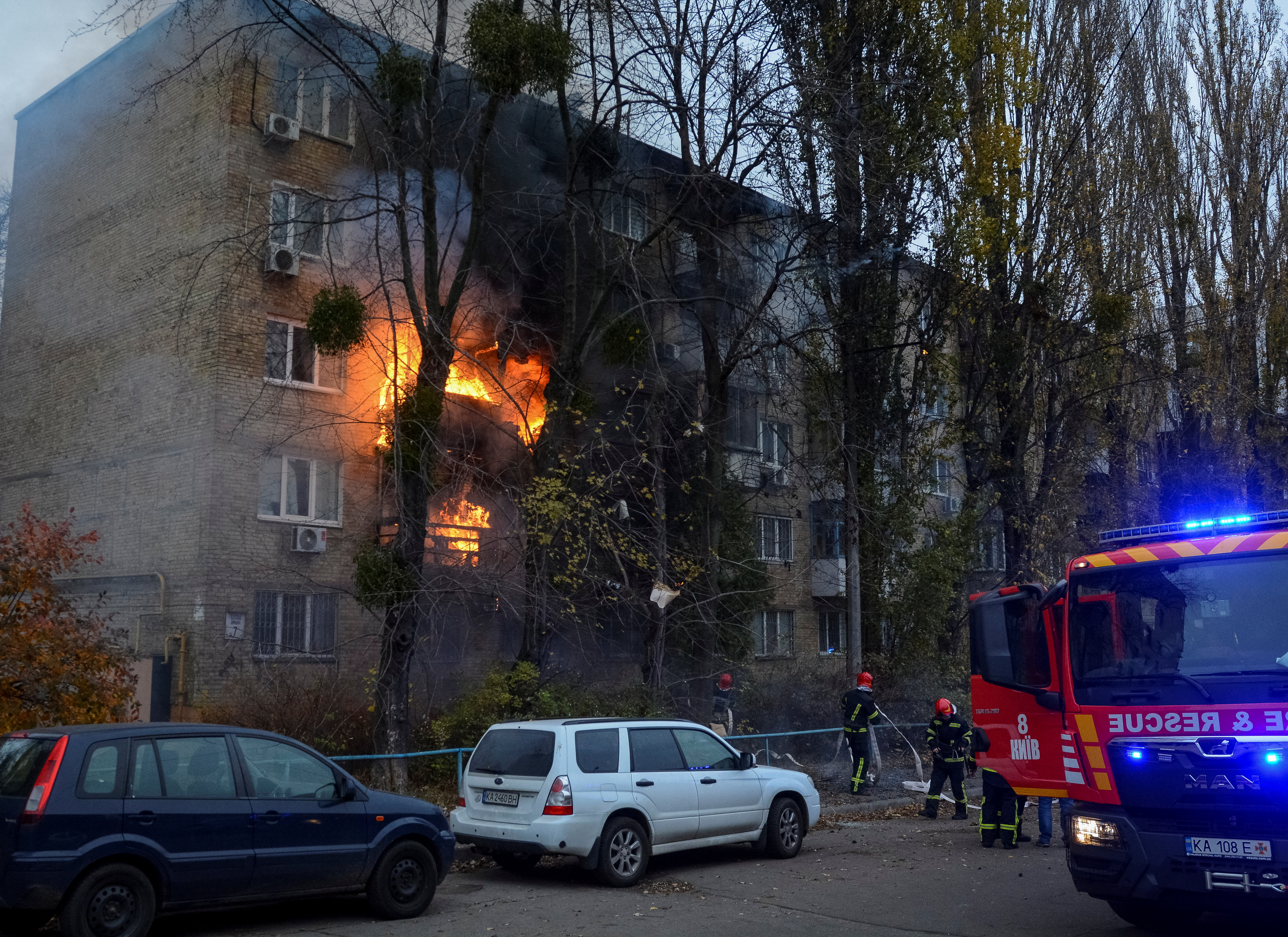 Firefighters work to put out a fire in a residential building hit by a Russian missile strike.