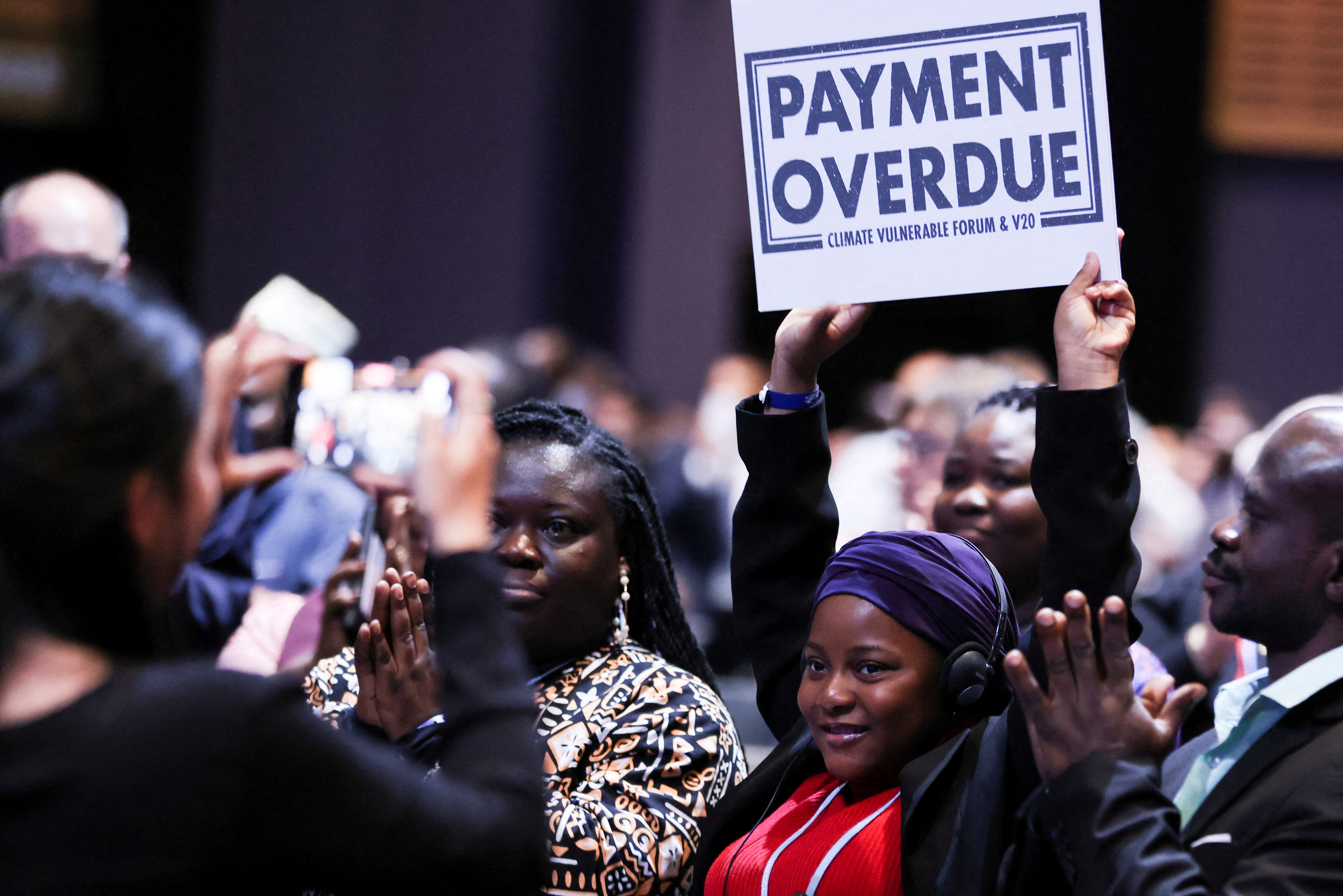 Nakeeyat Dramani Sam holds up a placard at an informal stocktaking session during the COP27 climate summit, in Sharm el-Sheikh