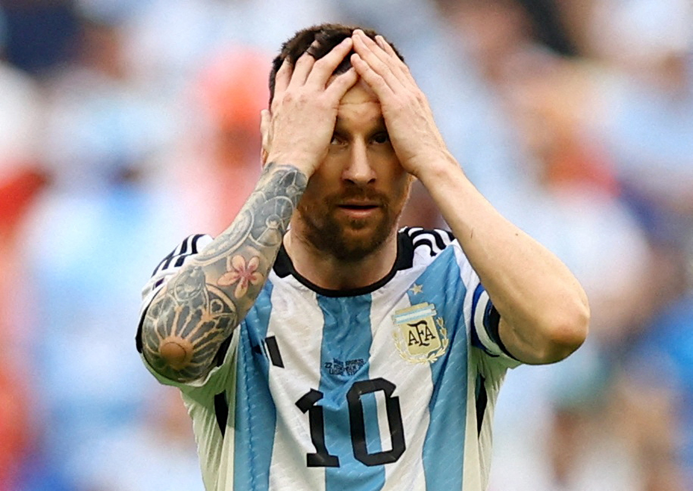 Argentina's Lionel Messi holds his head in his hands.