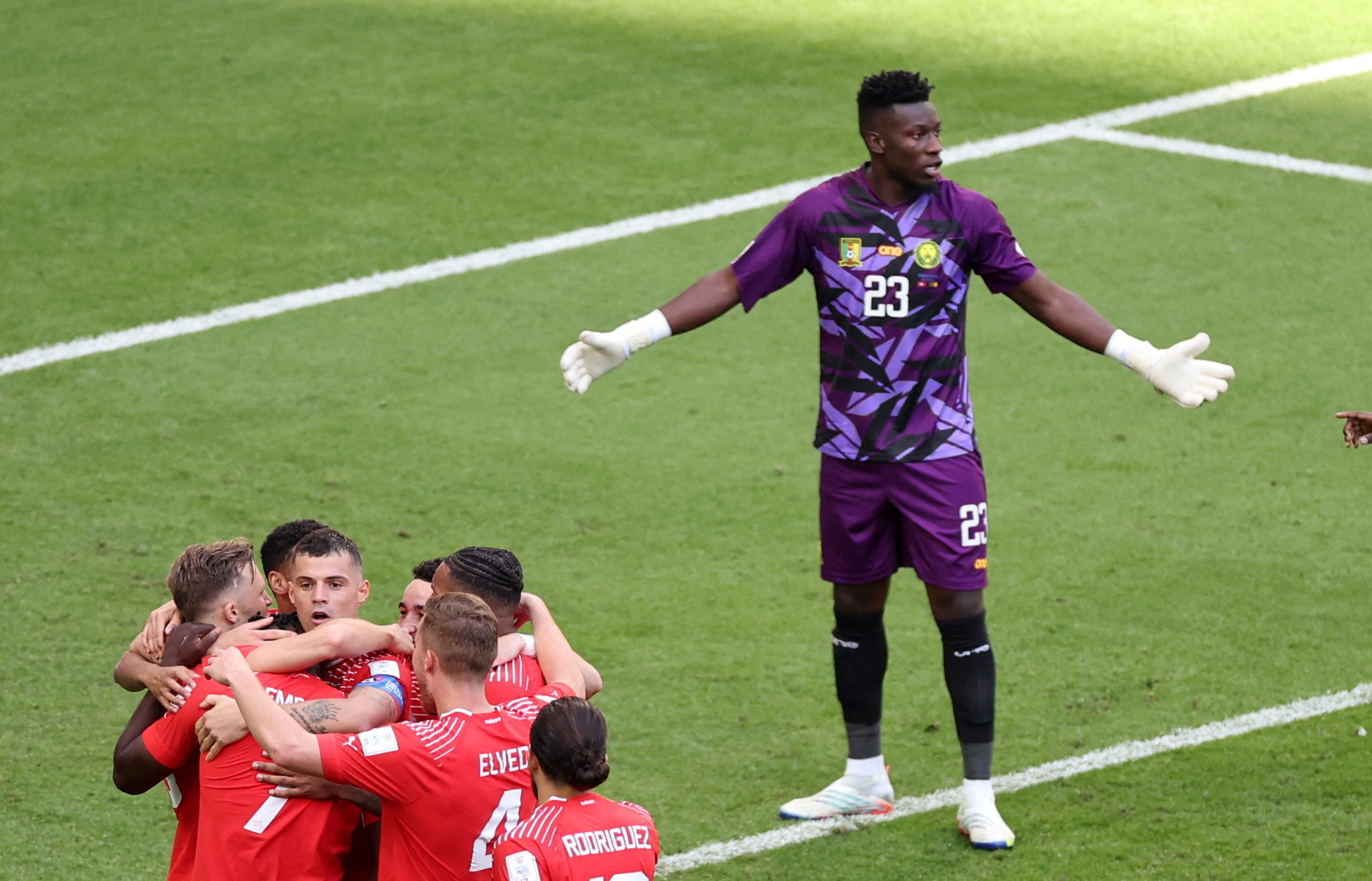 Switzerland's Breel Embolo celebrates scoring their first goal with teammates as Cameroon's Andre Onana reacts