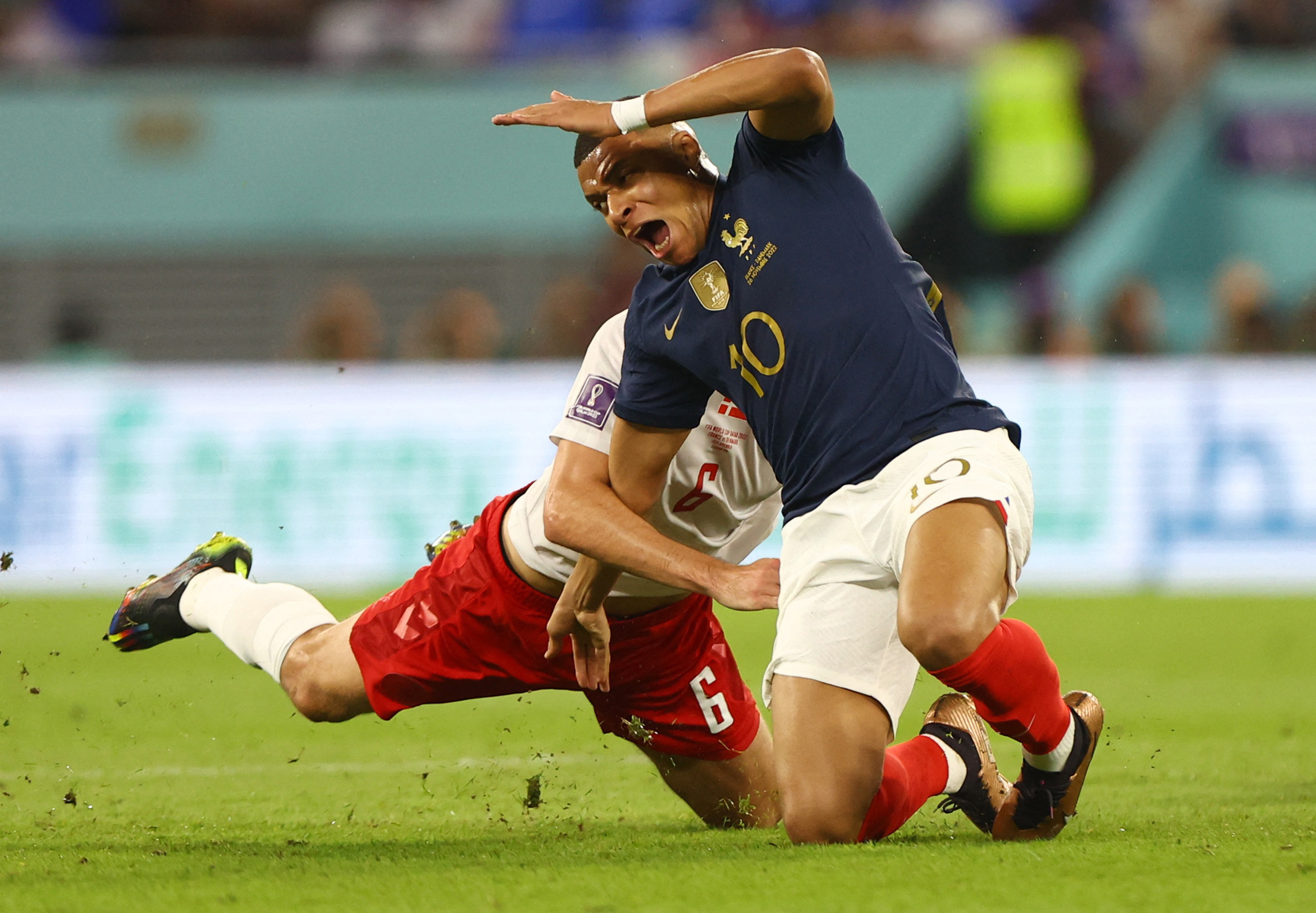 enmark's Andreas Christensen fouls France's Kylian Mbappe and subsequently receives a yellow card