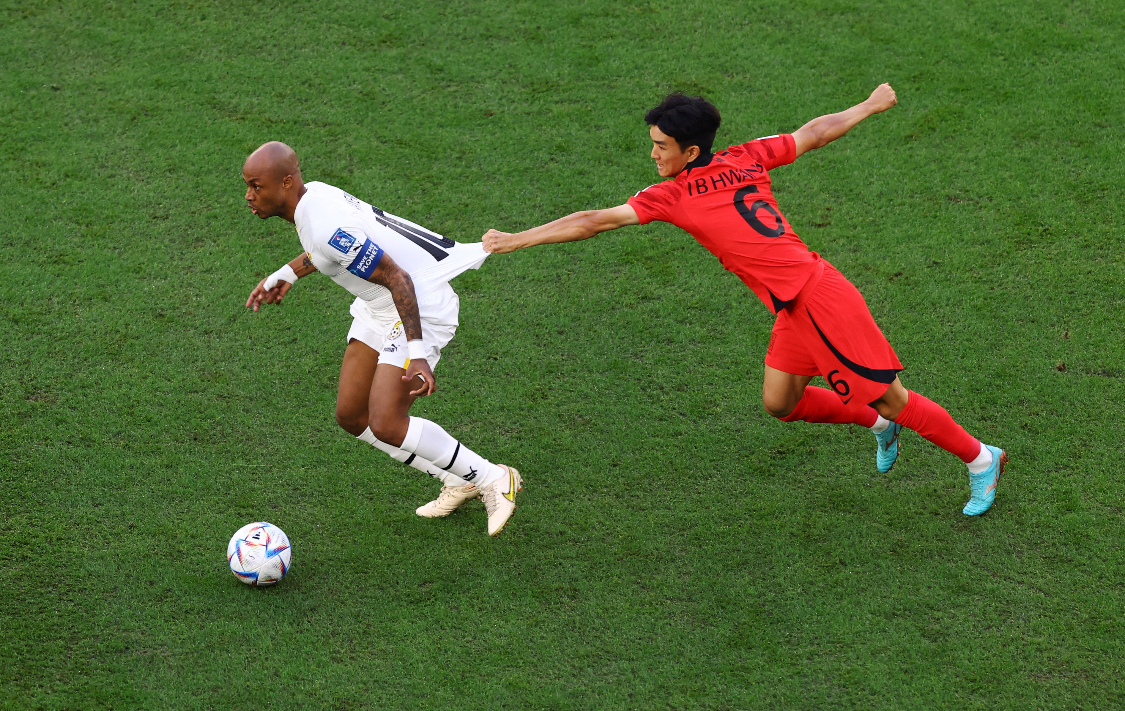 Ghana's Andre Ayew in action with South Korea's Hwang In-beom in the FIFA World Cup South Korea vs Ghana match.