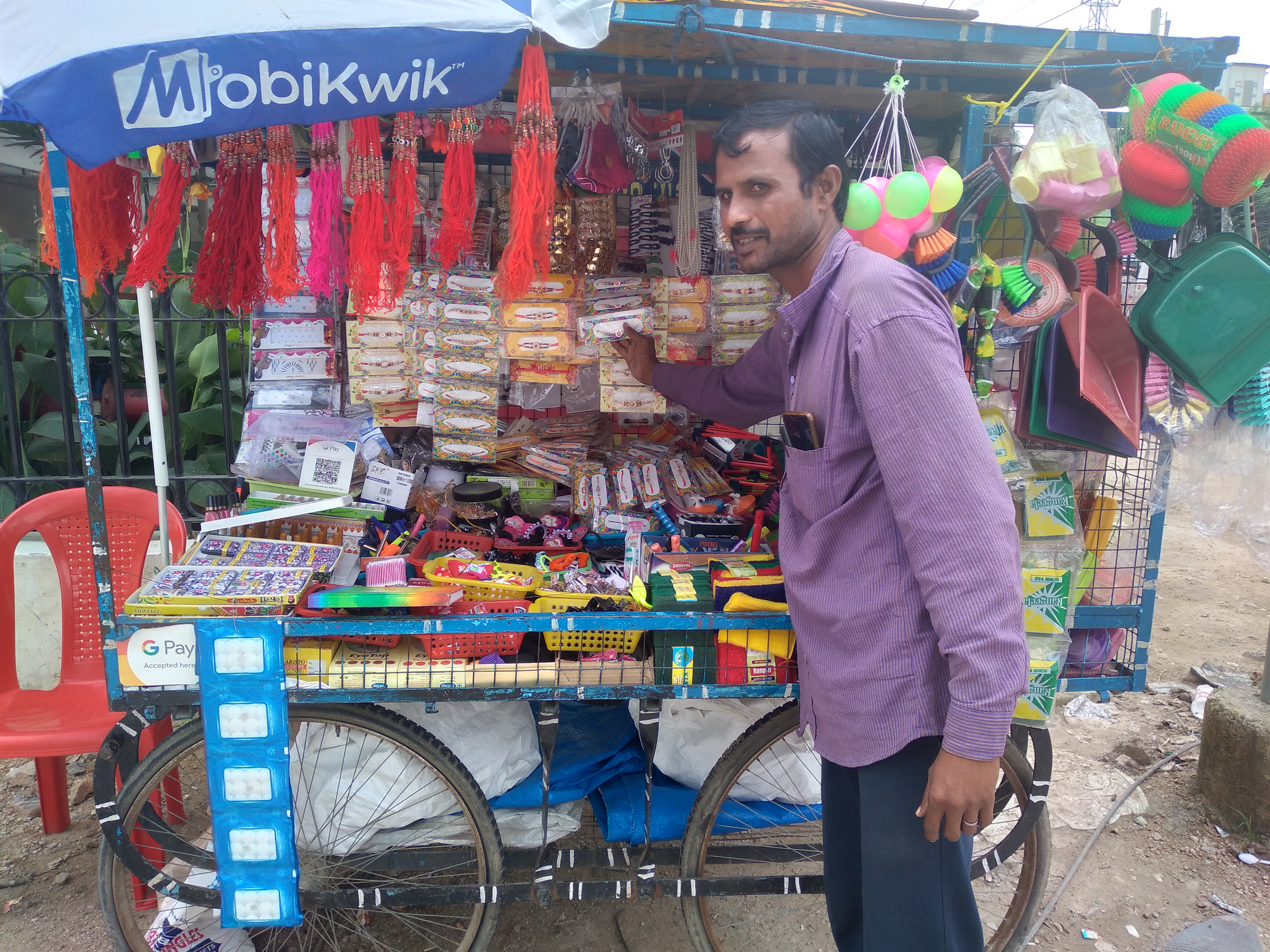 A pushcart vendor in Hyderabad, India, next to his stall