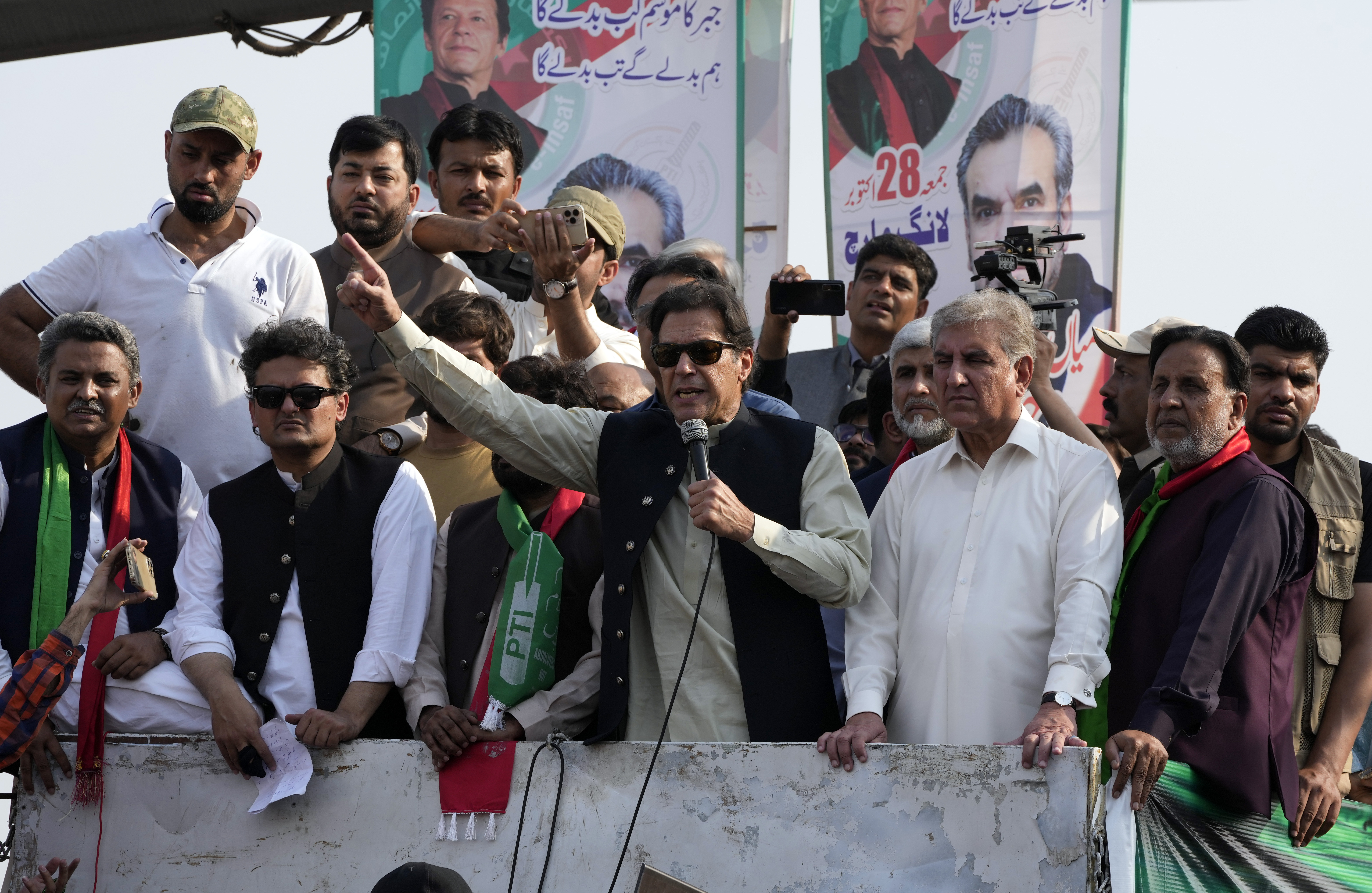 Pakistan's former Prime Minister Imran Khan, center, addresses to his supporters at a rally in Lahore, Pakistan