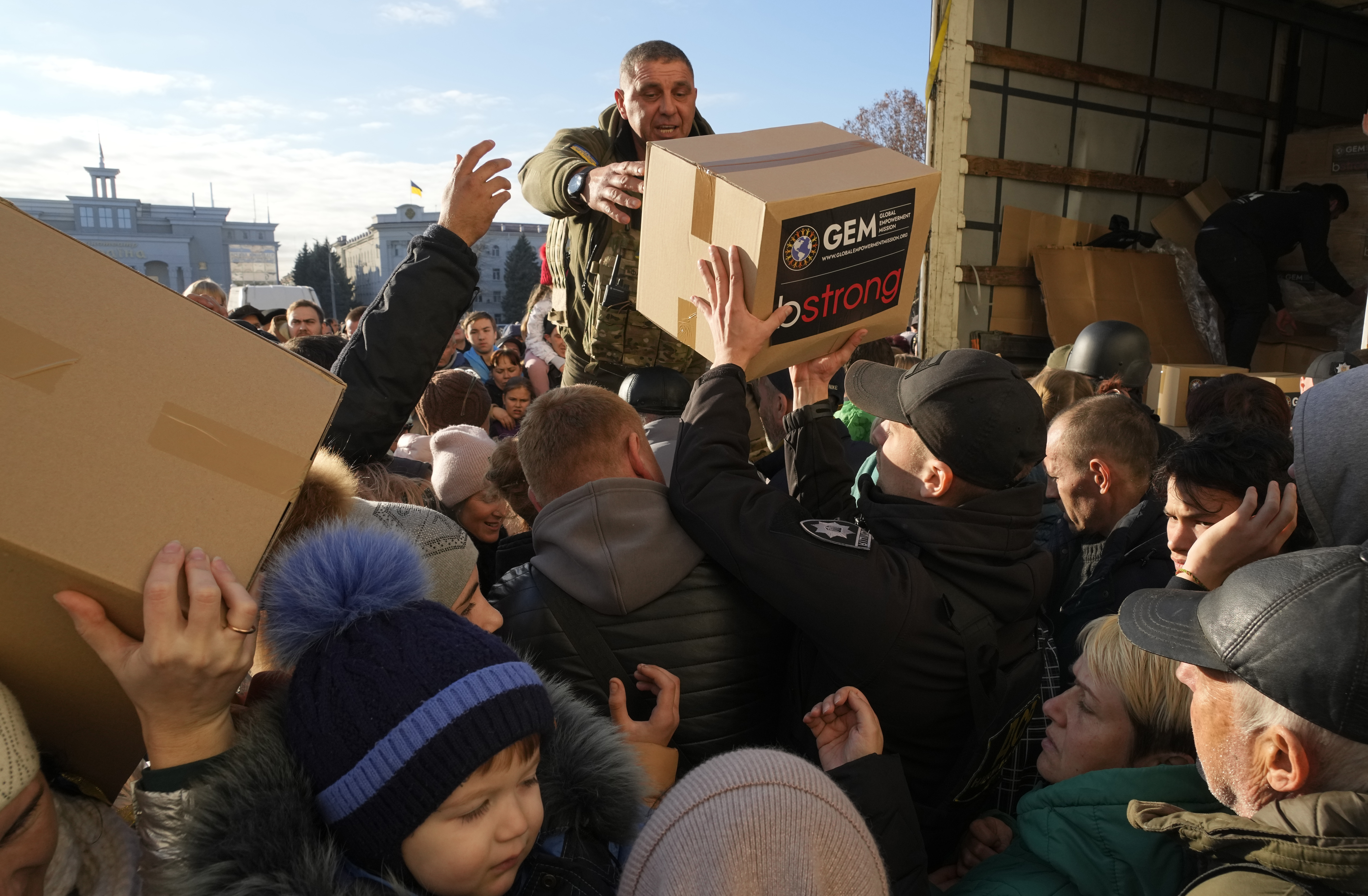 People receive humanitarian aid on central square in Kherson