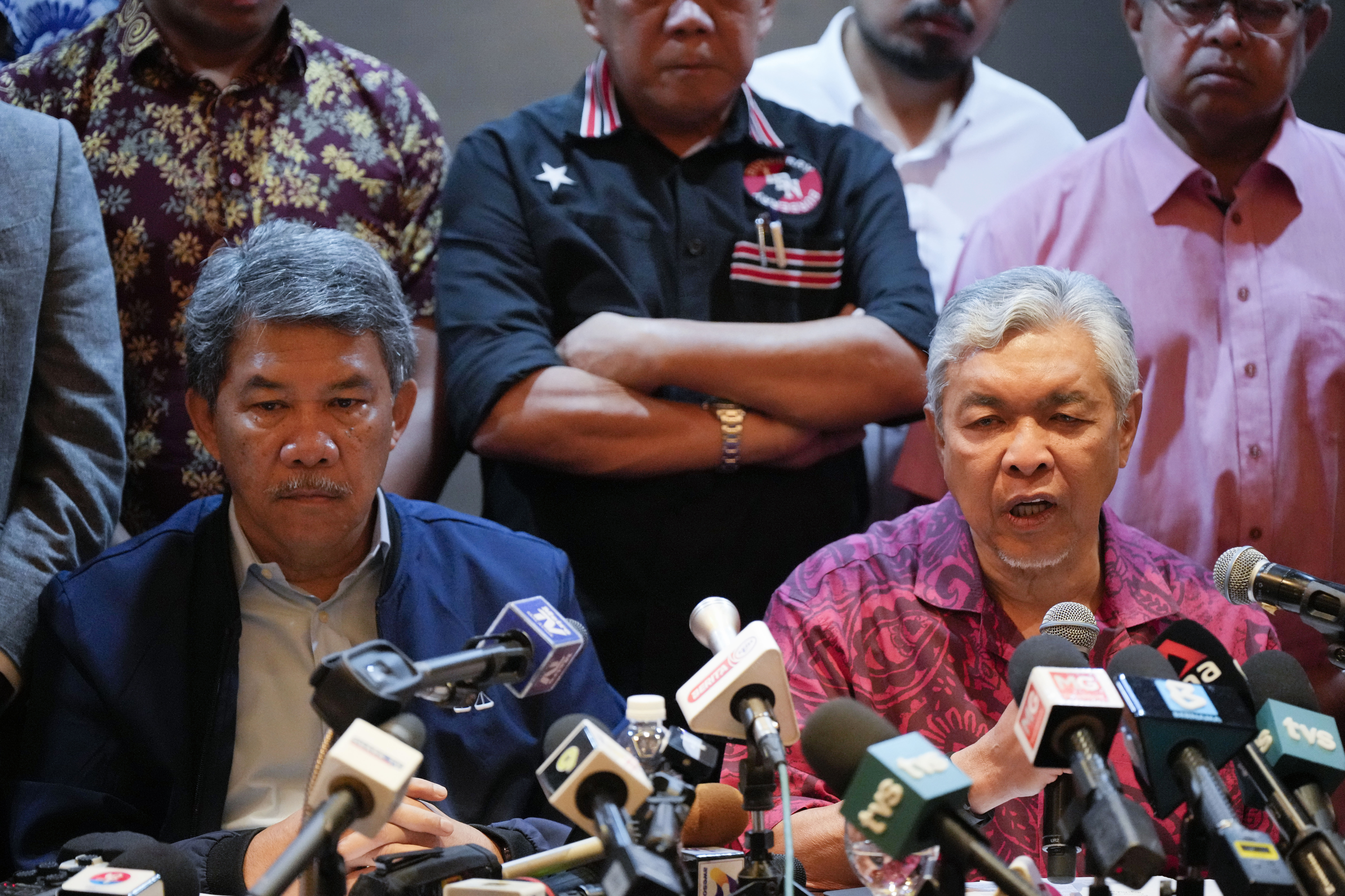 Ahmad Zahid Hamidi speaking to the media after discussions with PH. He looks serious and is surrounded by other lawmakers from his party