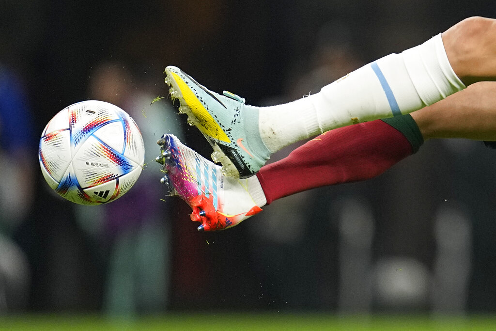Uruguay's Matias Vecino (top) fights for the ball with Portugal's Pepe during the World Cup group H soccer match between Portugal and Uruguay, at the Lusail Stadium in Lusail, Qatar, on November 28, 2022 [Abbie Parr/AP Photo]
