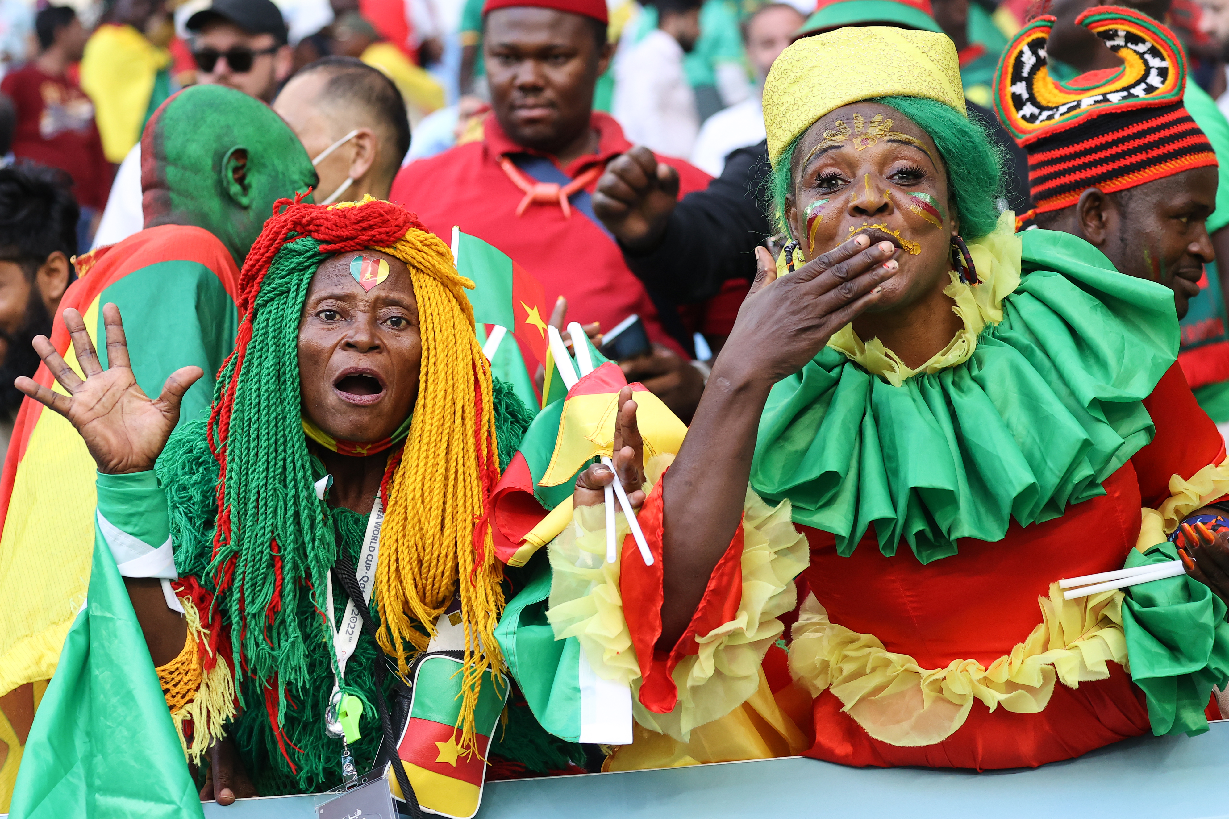 Cameroon fans dressed in colourful attire cheer for their team at Al Janoub Stadium in Doha, Qatar on Monday, November 28, 2022 [Showkat Shafi/Al Jazeera]
