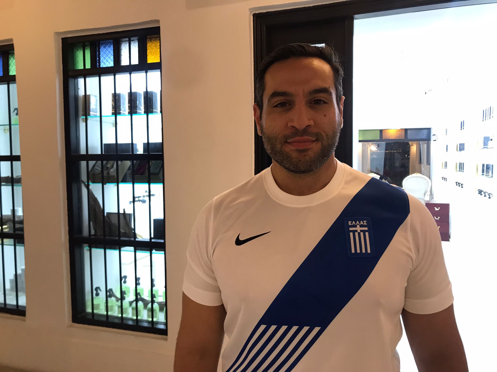 Shervin Sharifi standing in front of a shop in Doha, Qatar.