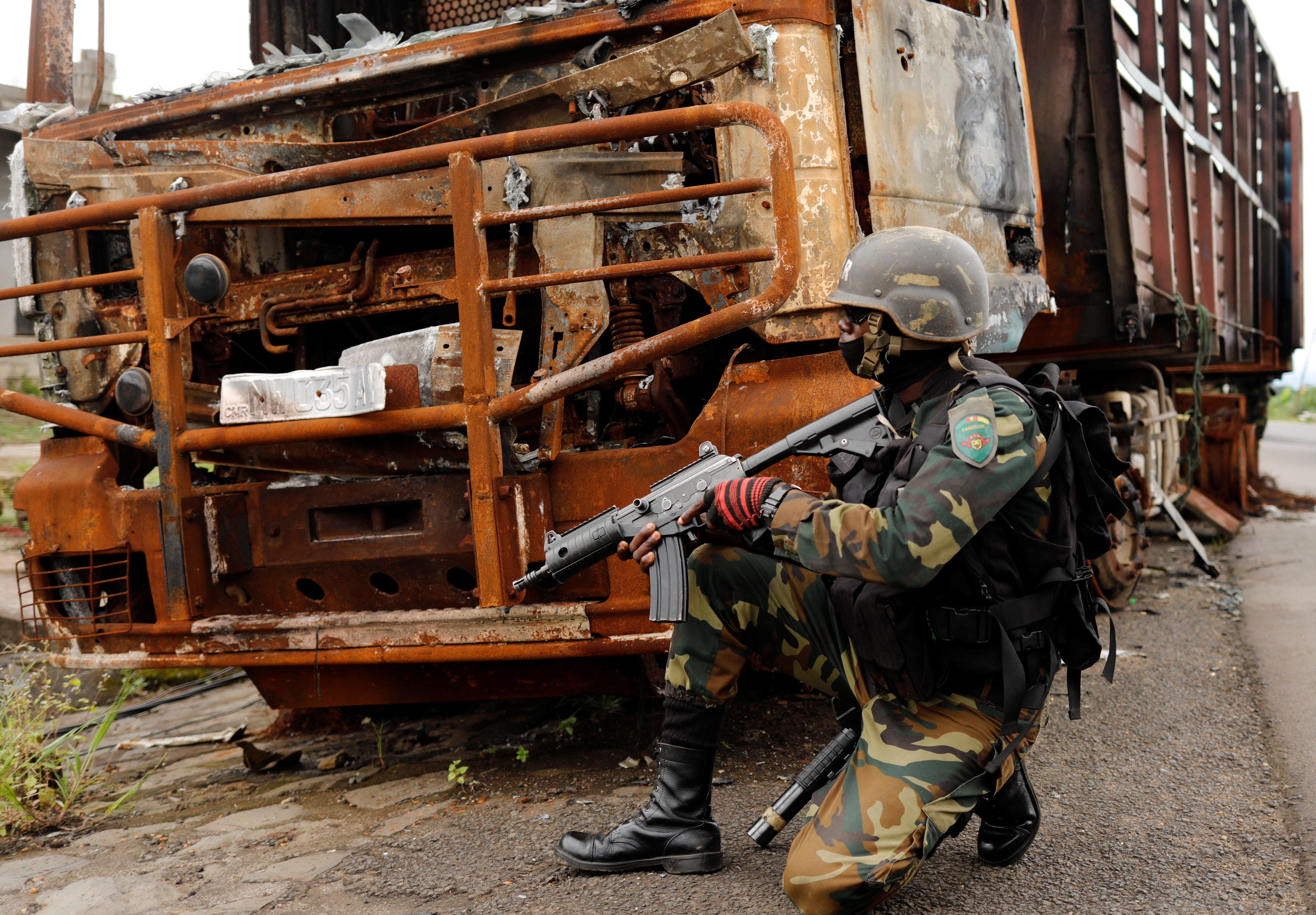 A Cameroonian elite Rapid Intervention Battalion (BIR) member patrols the abandoned village of Ekona near Buea in the anglophone southwest region, Cameroon