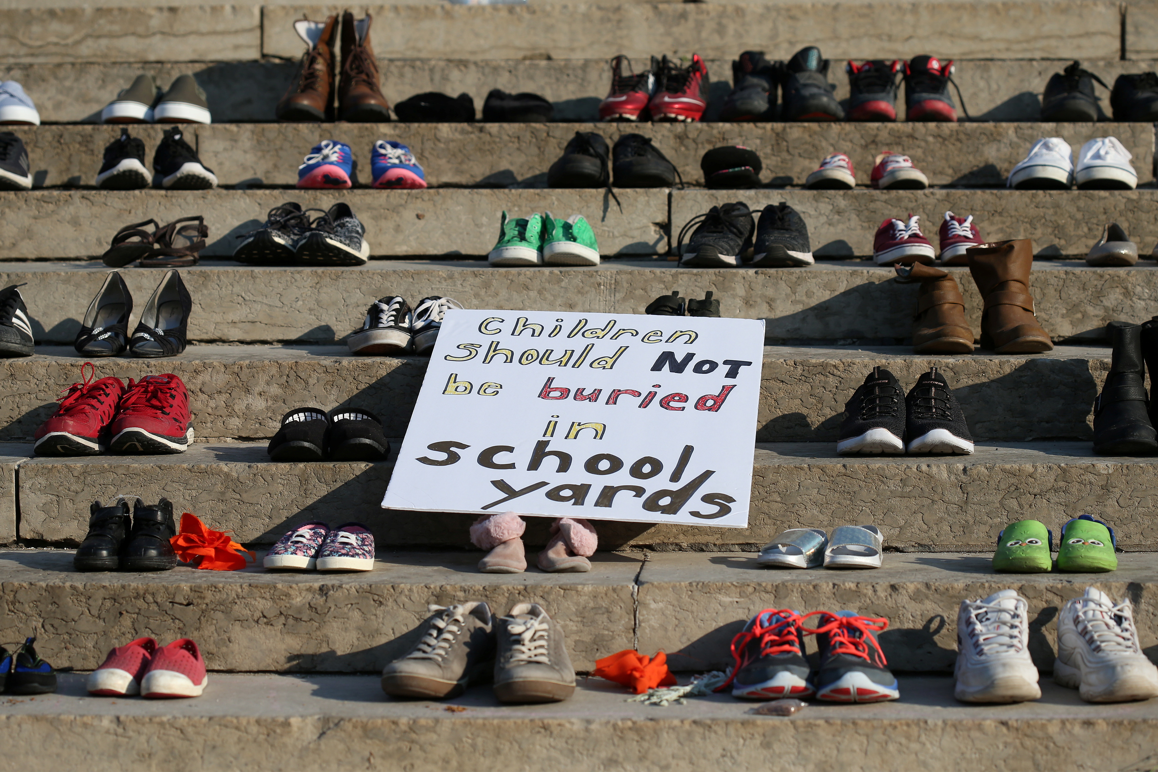 Shoes sit on the steps of the provincial legislature, placed there following the discovery of the remains of hundreds of children at former indigenous residential schools, on Canada Day in Winnipeg, Manitoba, Canada July 1, 2021.