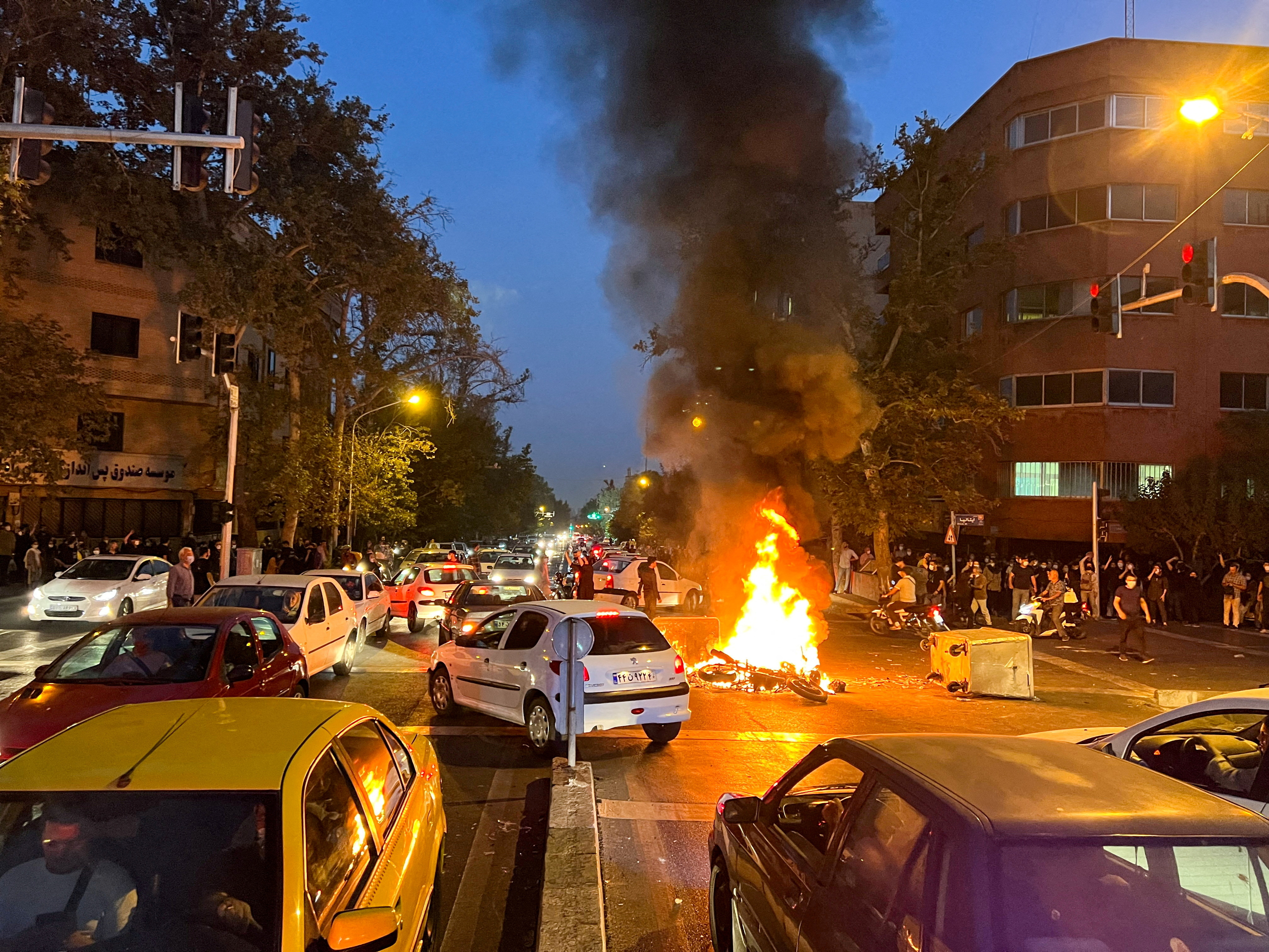 A vehicle burns during protests in Tehran