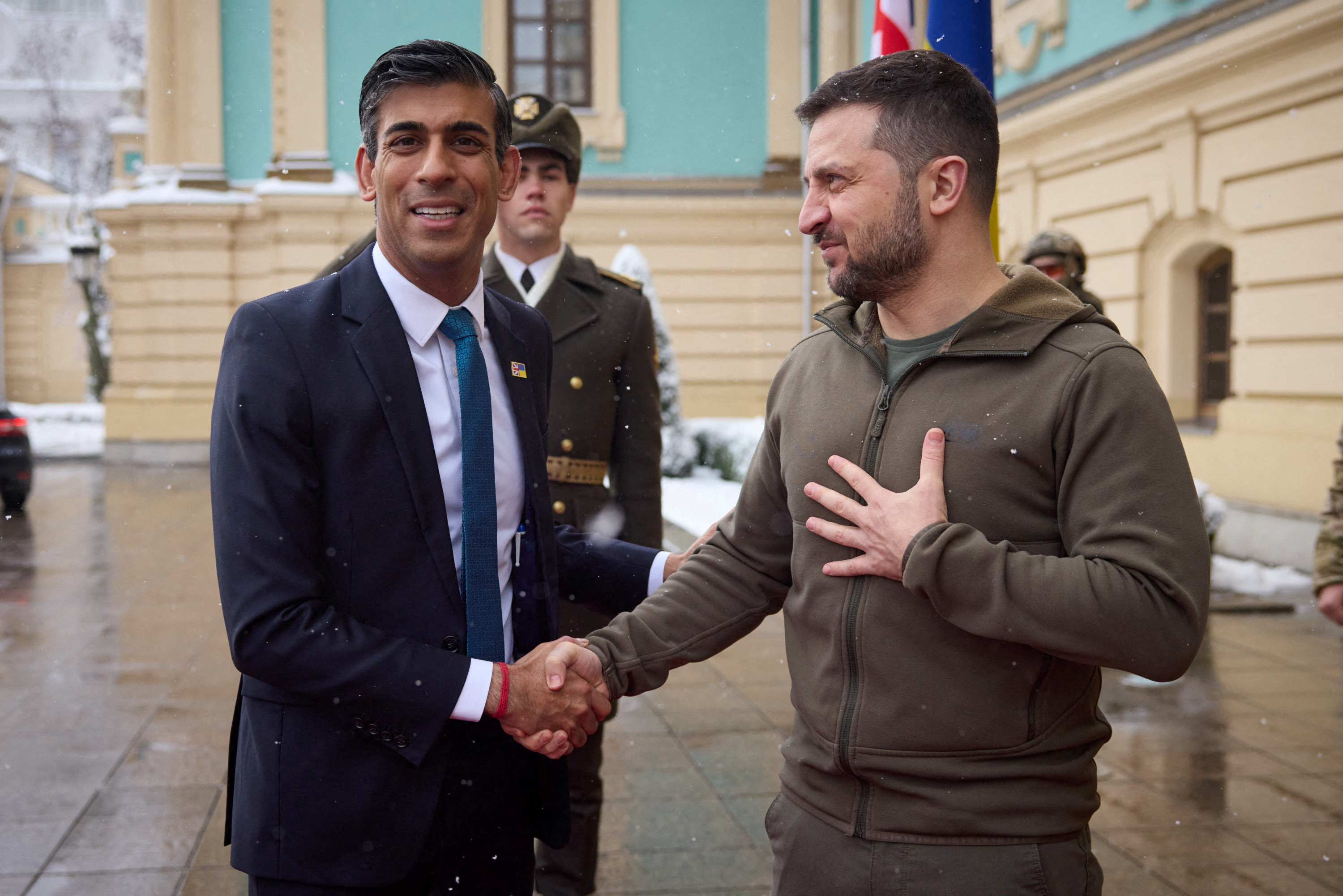 Ukraine's President Volodymyr Zelenskiy shakes hands with British Prime Minister Rishi Sunak during a meeting in Kyiv