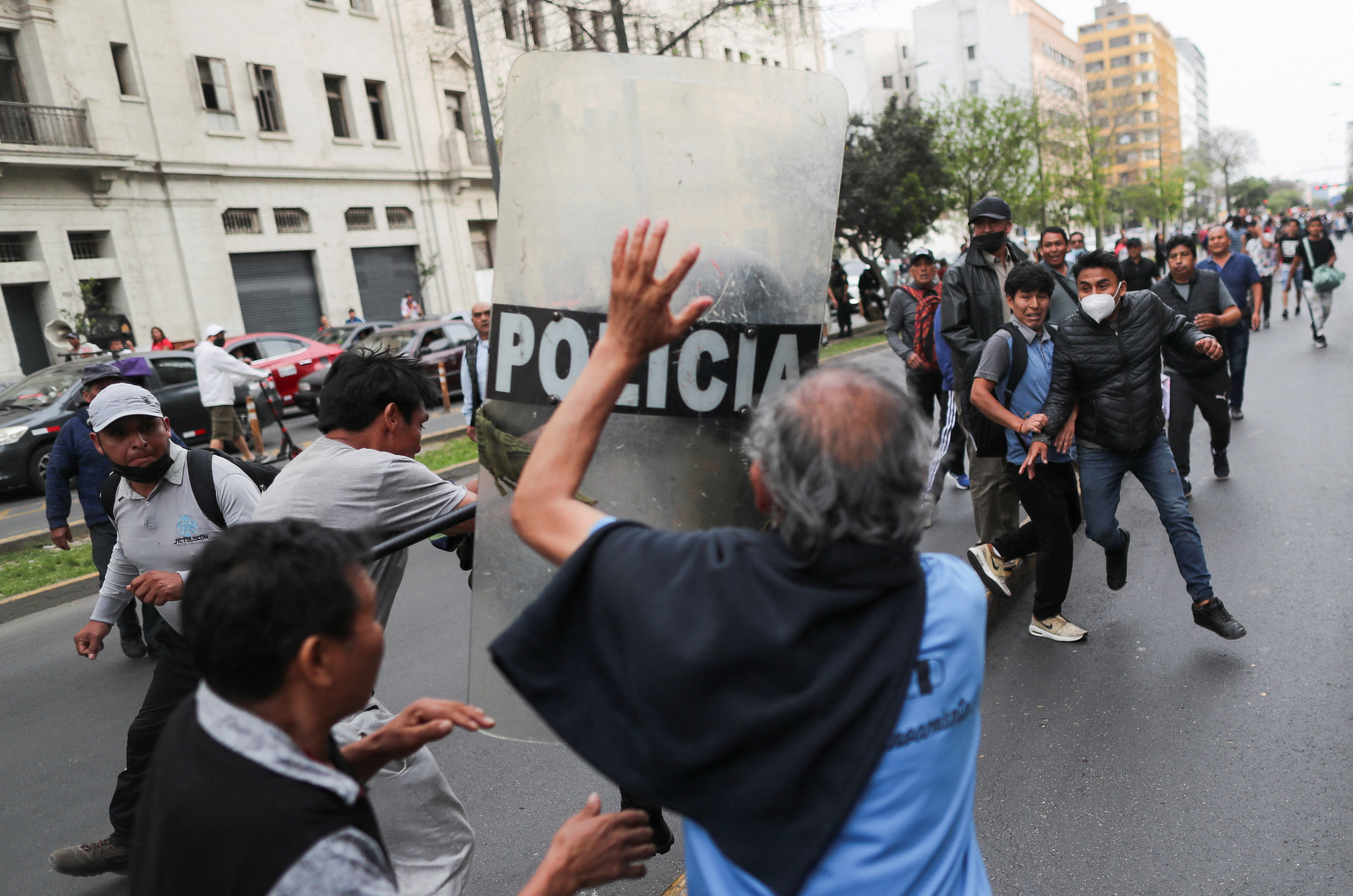 A police officer clashes with demonstrators