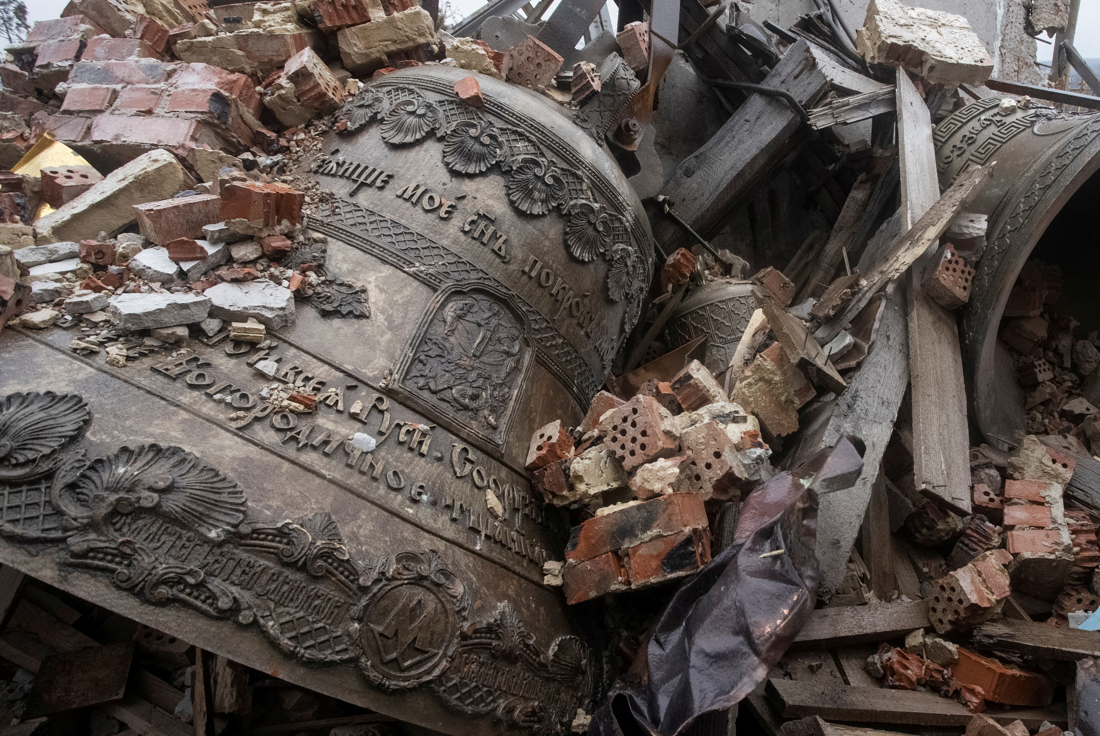 Bells are seen surrounded by debris of a destroyed Orthodox church in Donetsk region,