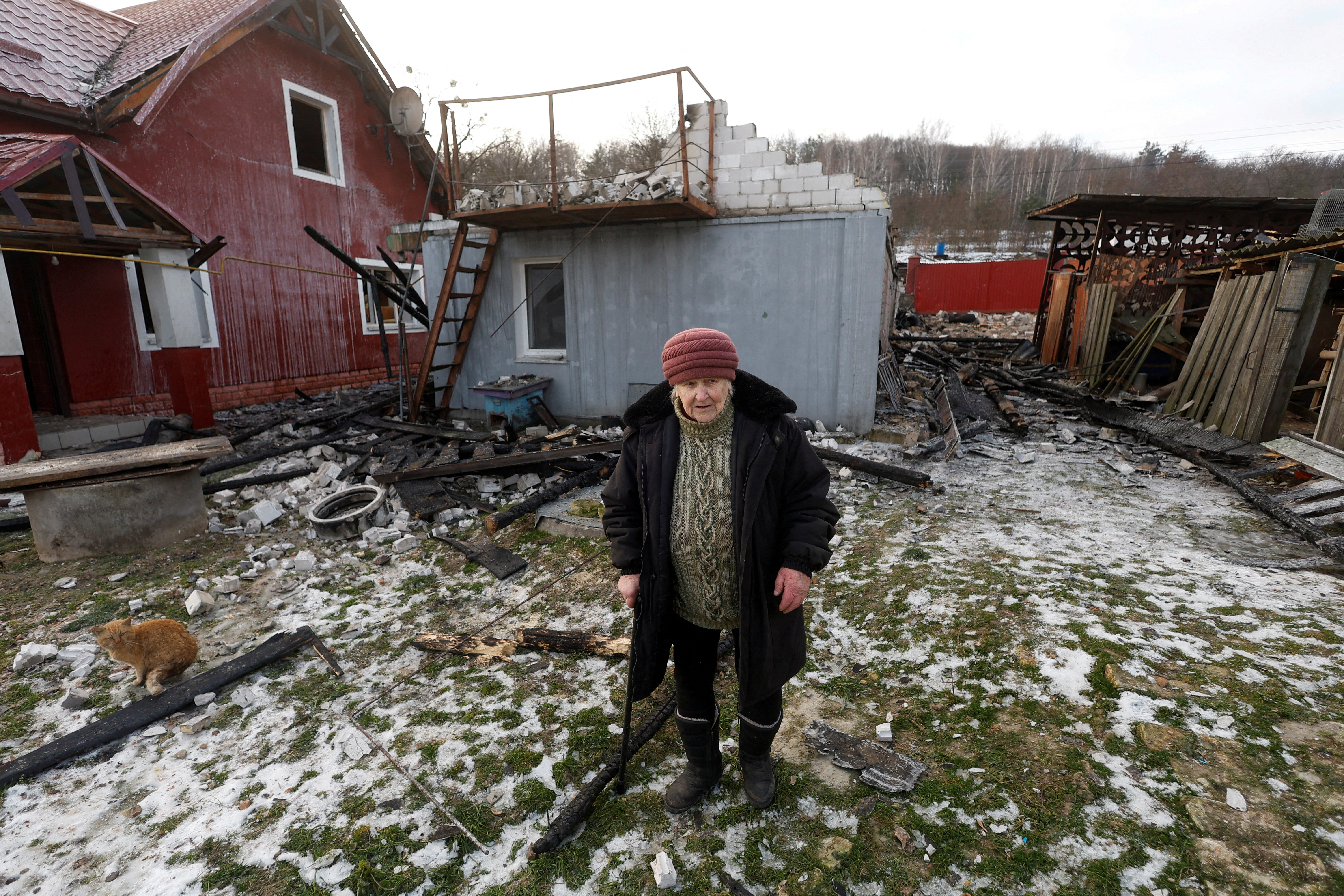 Local resident Olha Kobzarenko stands at her backyard, damaged during a Russian drone strike, amid Russia's attack on Ukraine, in the village of Stari Bezradychi, in Kyiv region, Ukraine December 19, 2022. REUTERS/Valentyn Ogirenko TPX IMAGES OF THE DAY