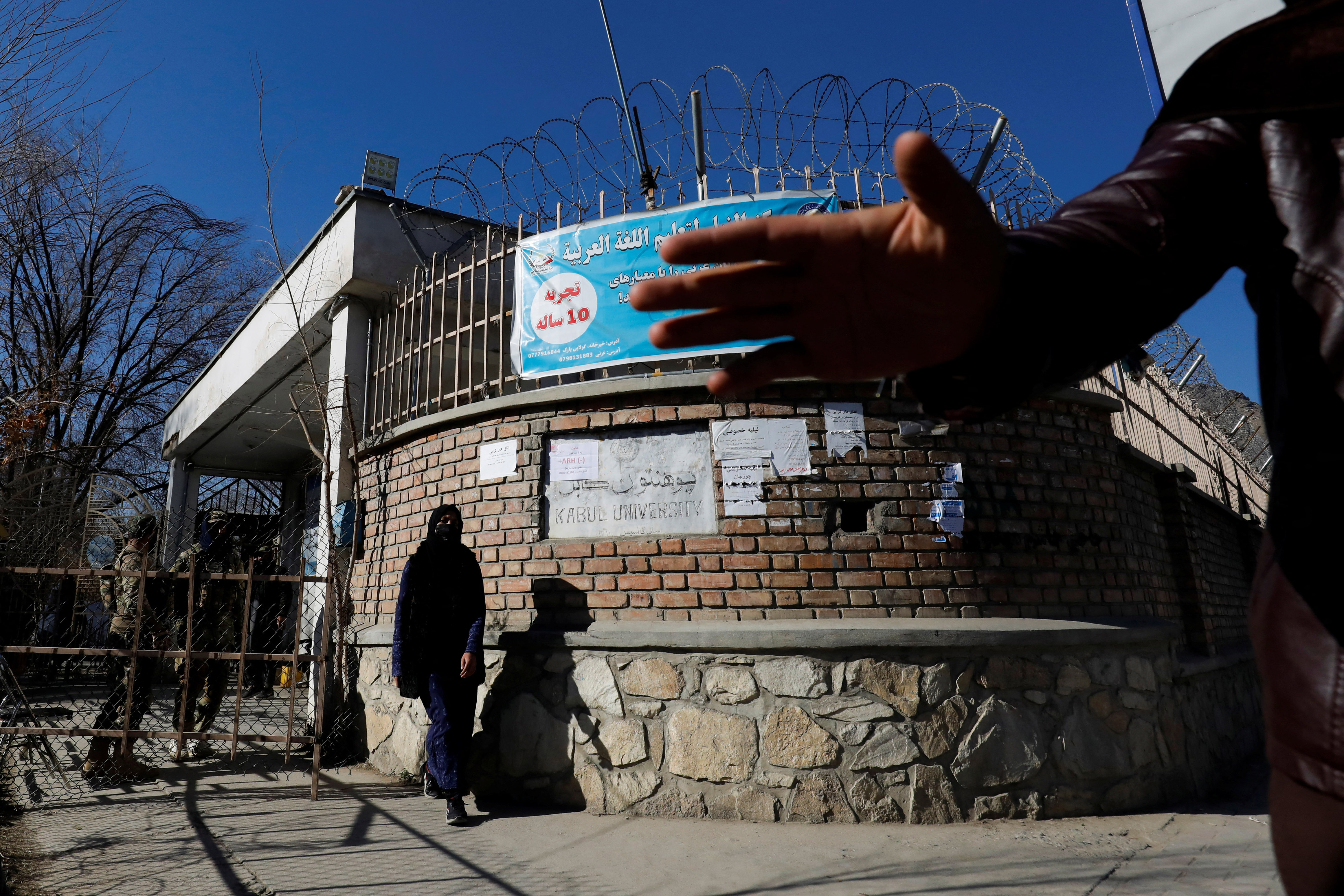 An Afghan student walks in front of the Kabul University