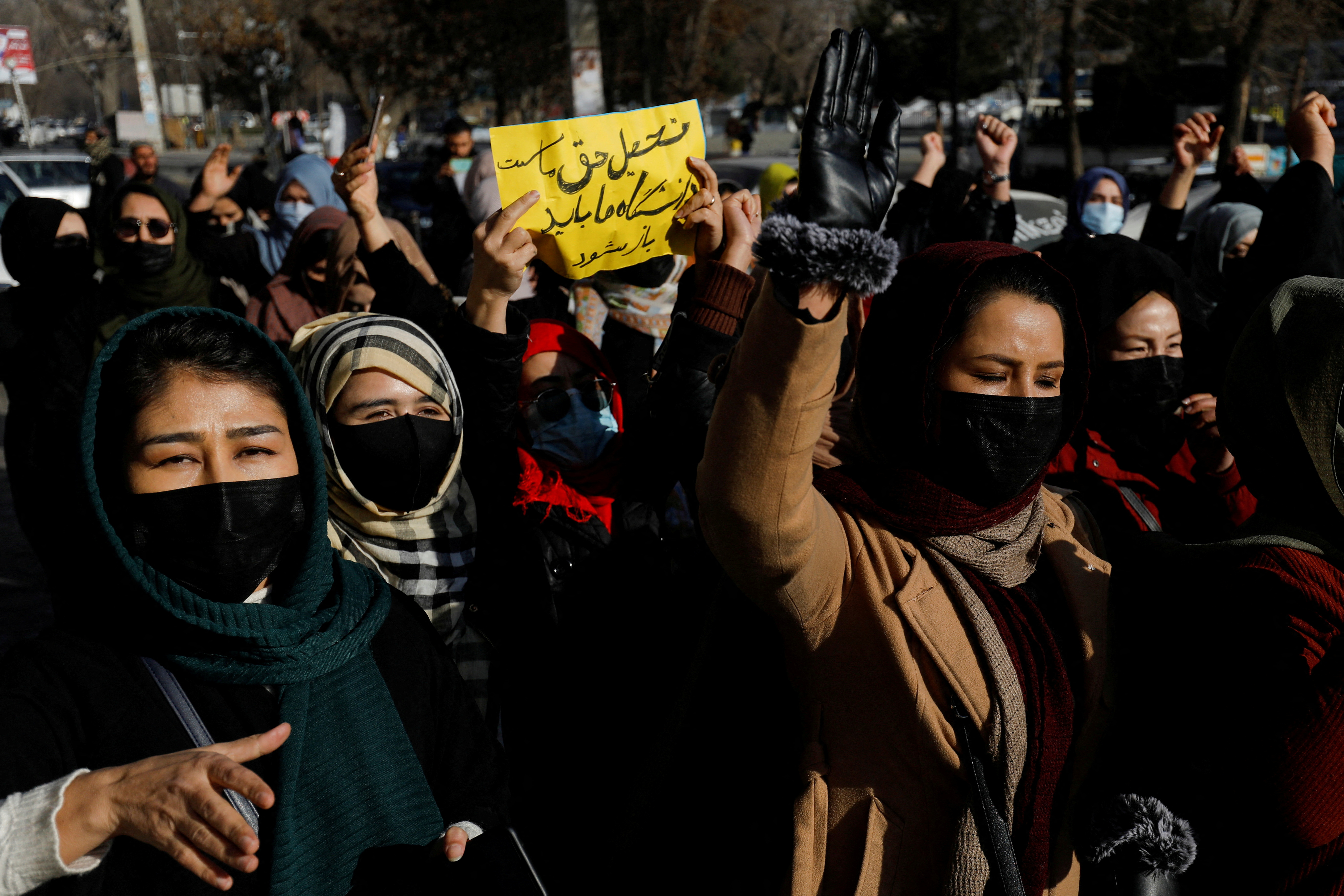Afghan women chant slogans in protest against the closure of universities