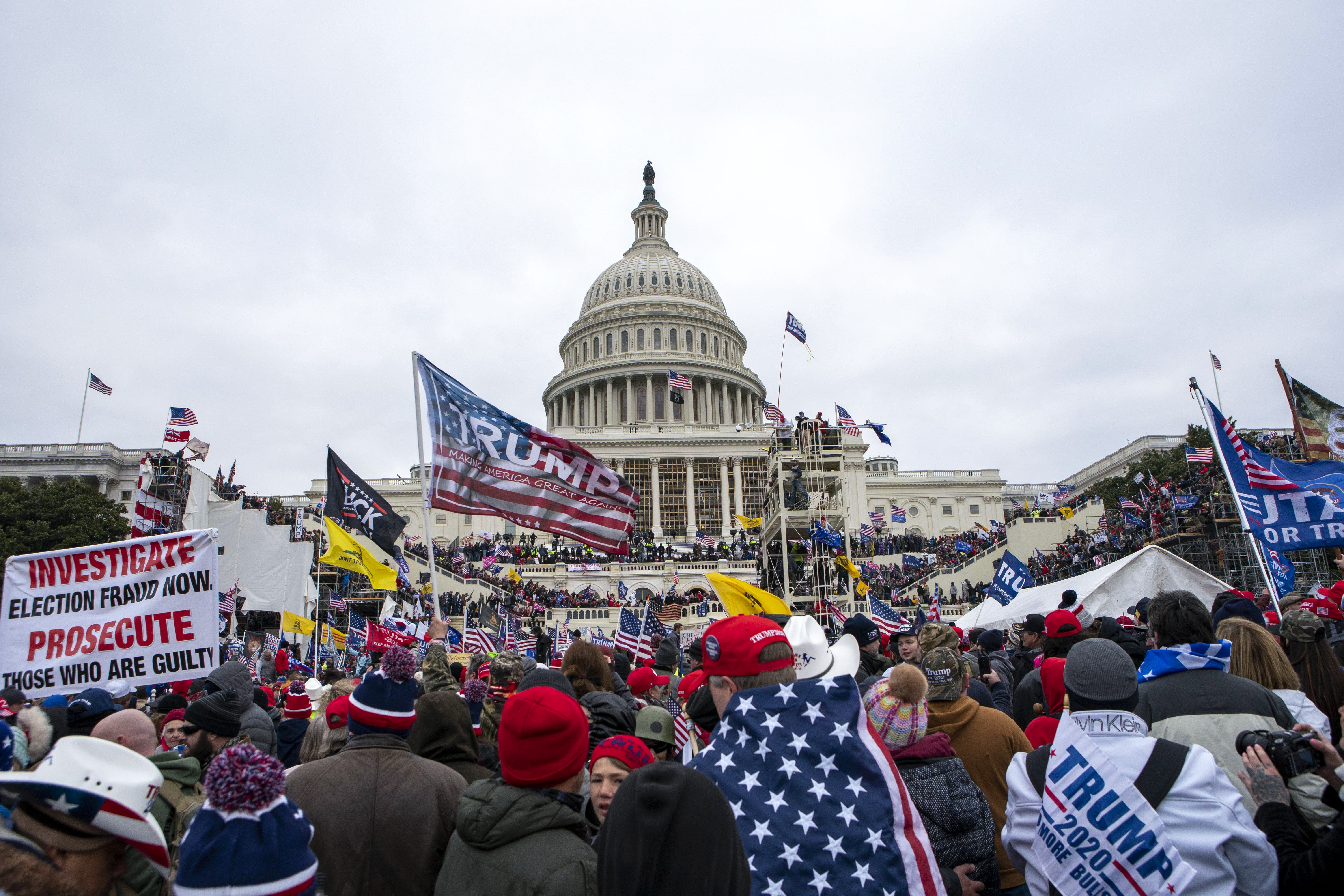 FILE - In this Jan. 6, 2021, file photo insurrections loyal to President Donald Trump rally at the U.S. Capitol in Washington. U.S. Capitol Police officers who were attacked and beaten during the Capitol riot filed a lawsuit Thursday, Aug. 26, against former President Donald Trump, his allies and members of far-right extremist groups, accusing them of intentionally sending insurrectionists to disrupt the congressional certification of the election in January. (AP Photo/Jose Luis Magana, File)