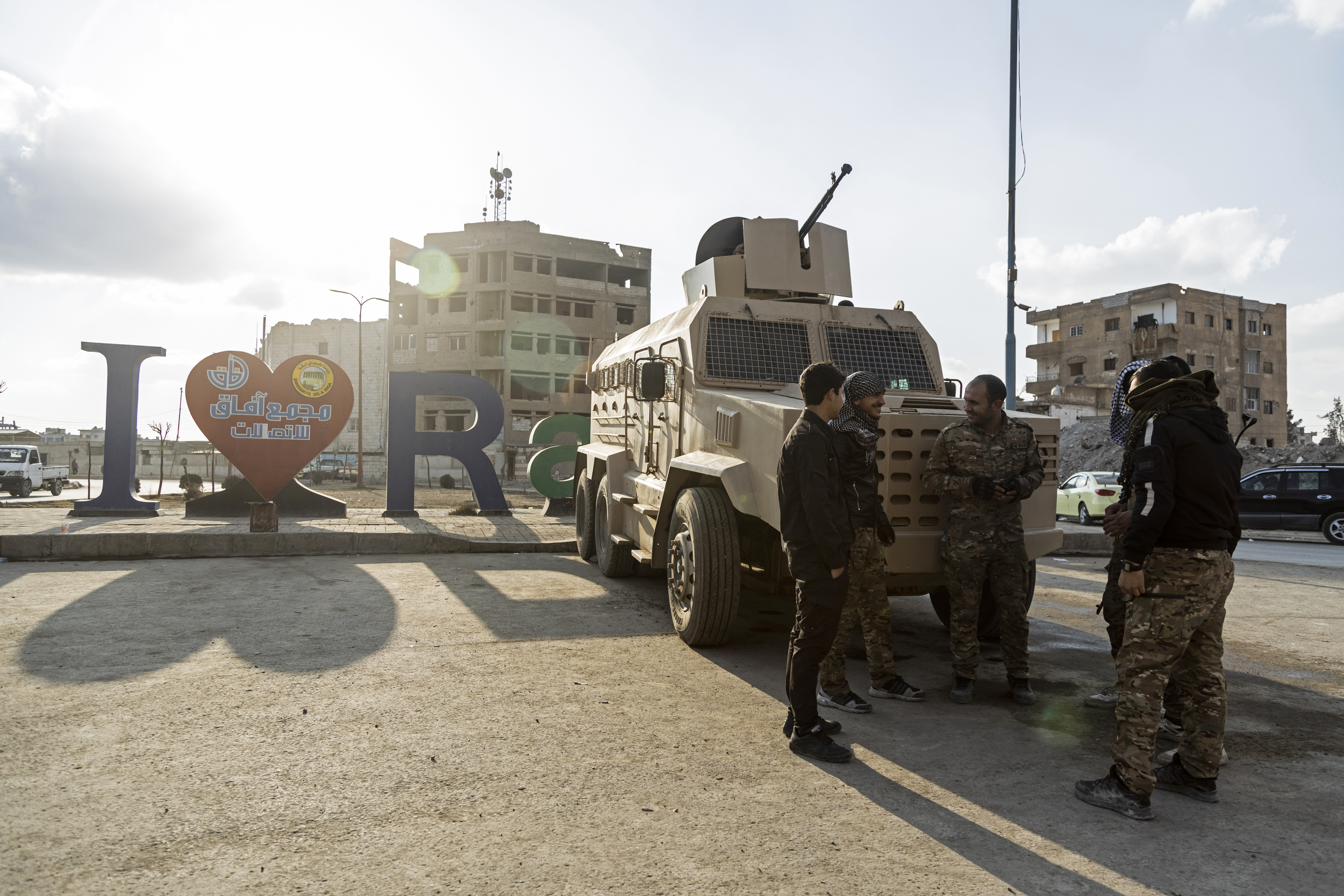 U.S.-backed Syrian Democratic Forces (SDF) fighters stand guard at Al Naeem Square, in Raqqa, Syria