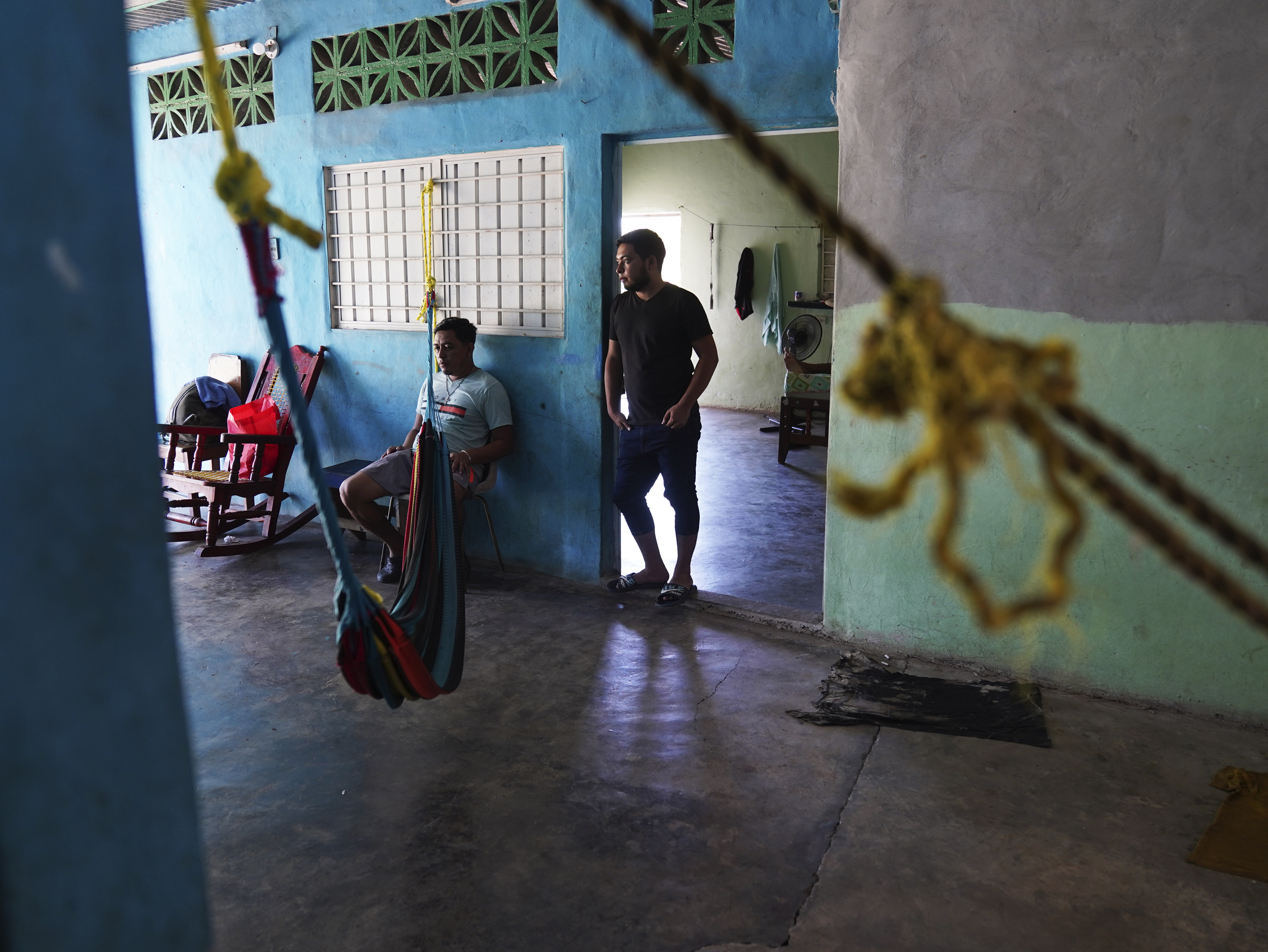 Migrants wait inside a local's home they are paying to stay in while waiting on the Mexican immigration office