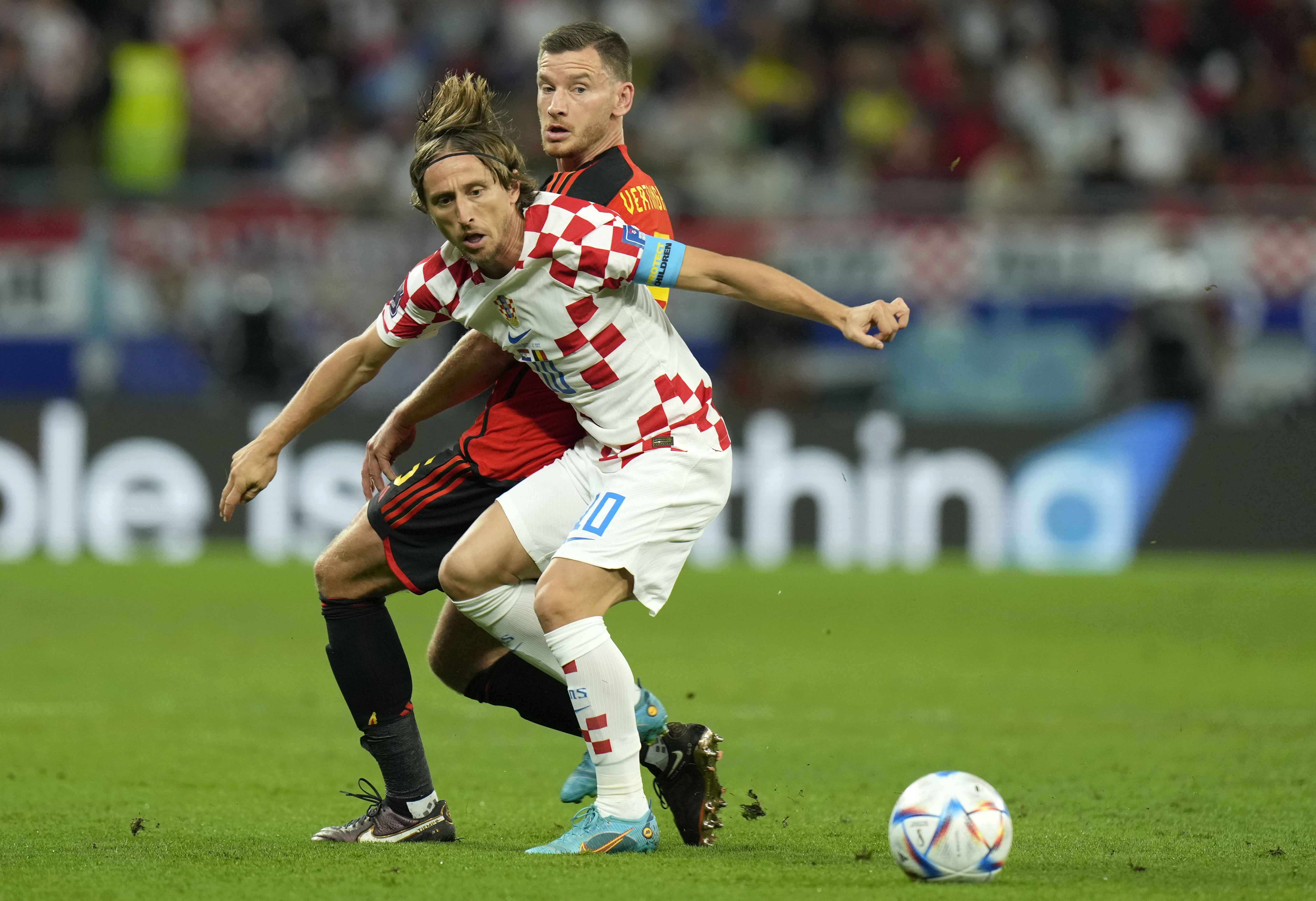 Croatia's Luka Modric, front, duels for the ball with Belgium's Jan Vertonghen