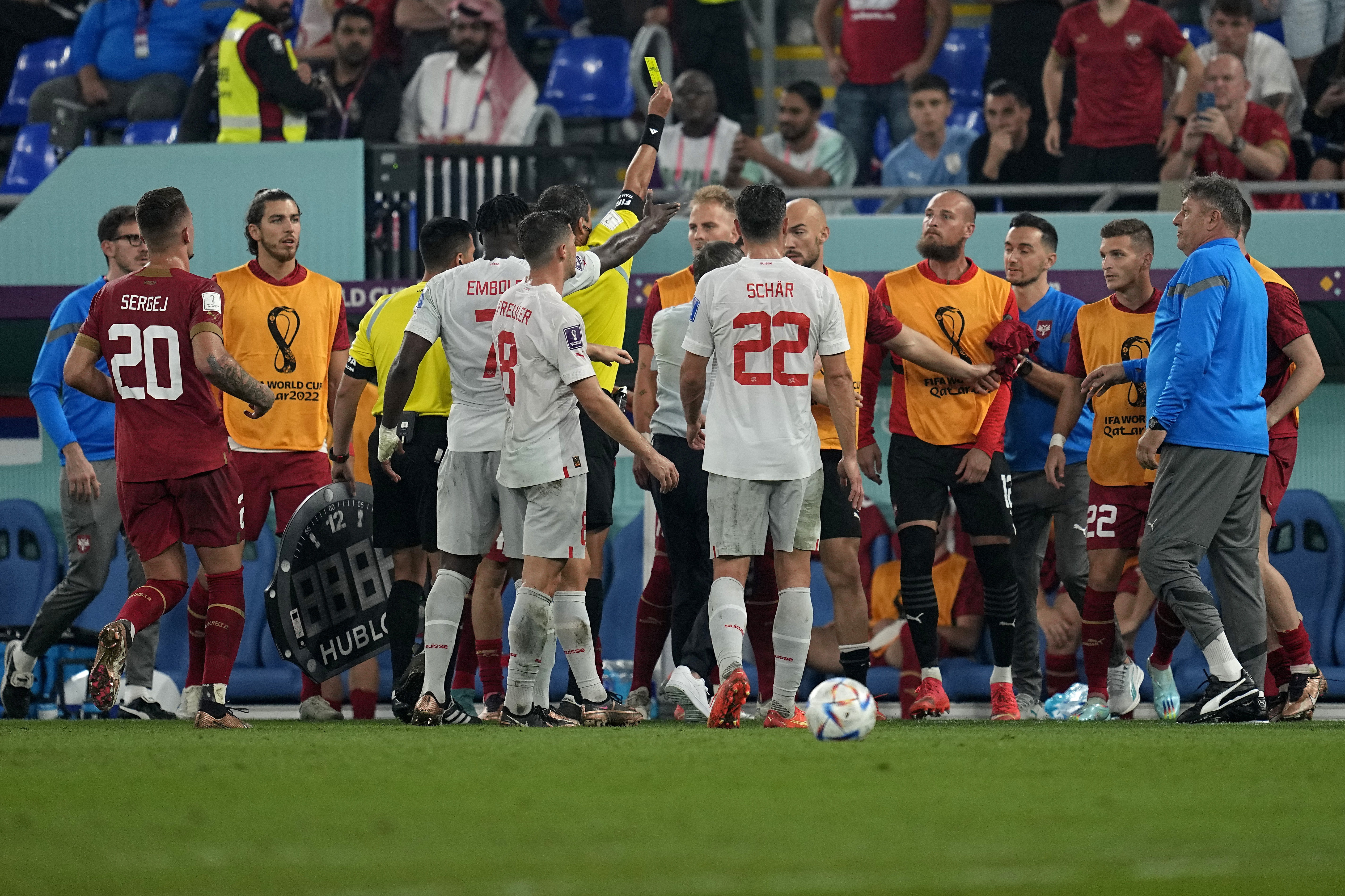 Serbian players from the bench argue with Switzerland players after Serbia's goalkeeper Predrag Rajkovic received a yellow card during the World Cup group G soccer match between Serbia and Switzerland, at the Stadium 974 in Doha, Qatar, Friday, Dec. 2, 2022. (AP Photo/Ebrahim Noroozi)