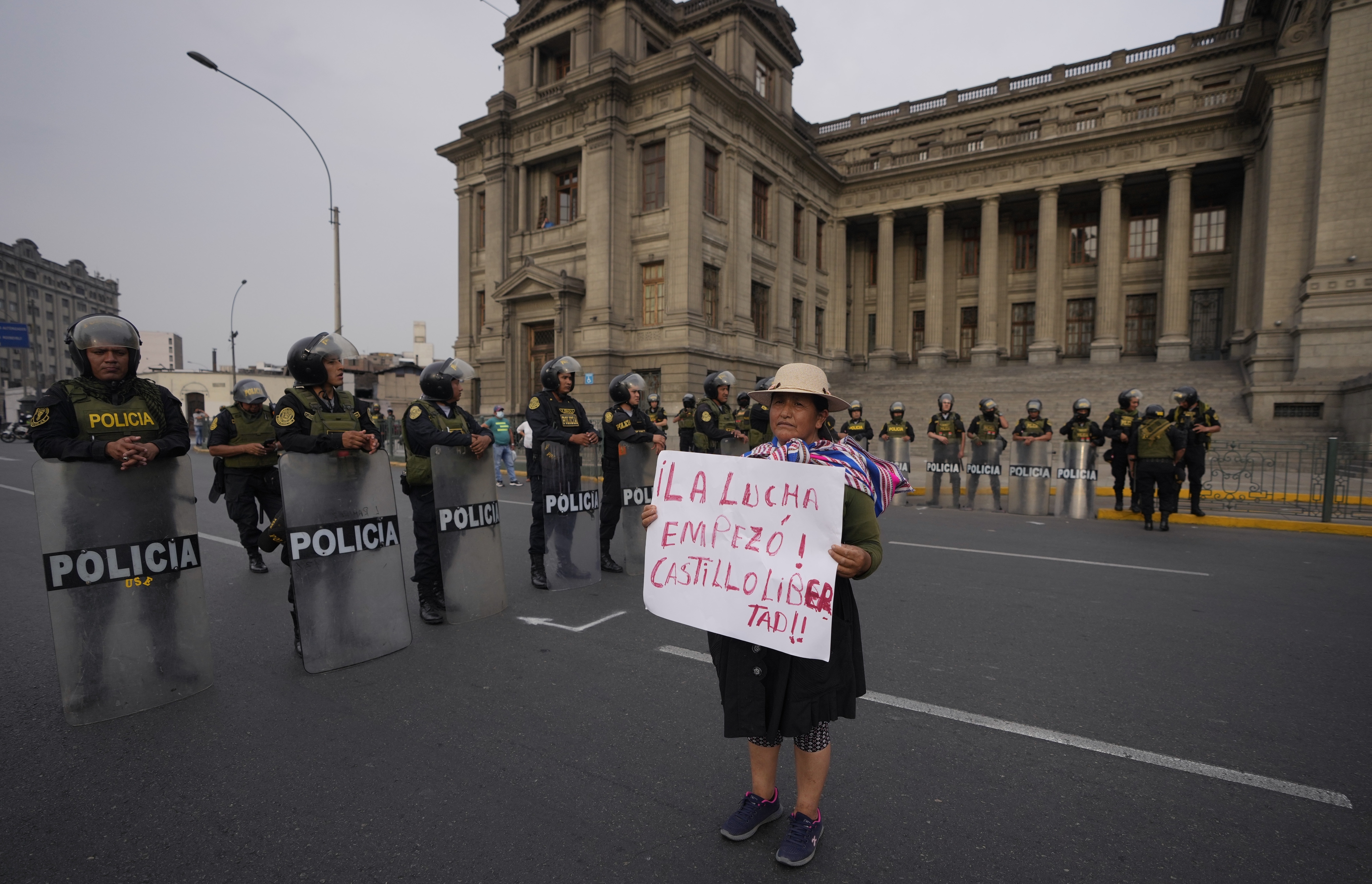 A supporter of outsed President Pedro Castillo holds a poster